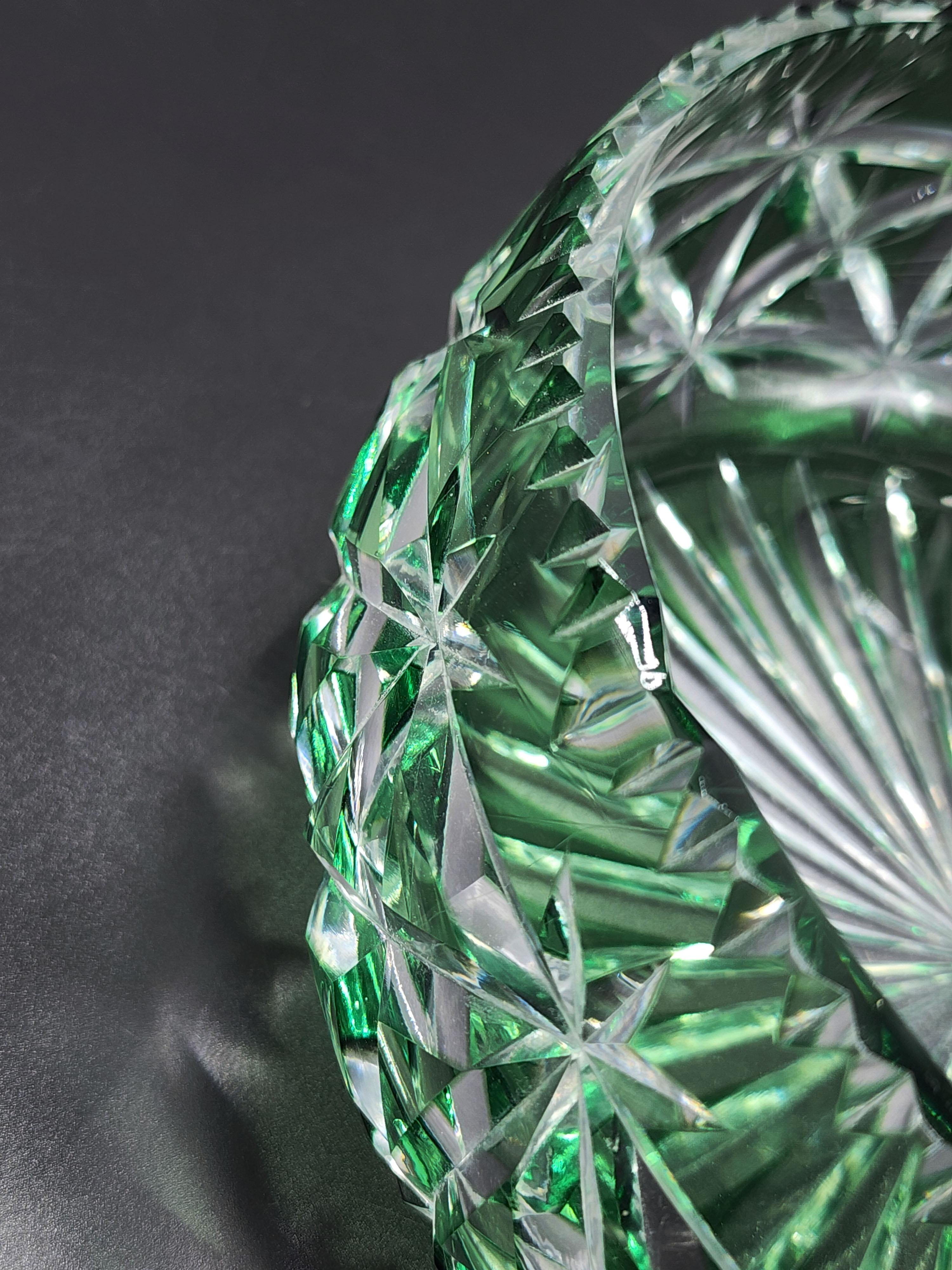 Val Saint Lambert Carved Crystal Centerpiece
Beautiful green carved crystal centerpiece with intricate design, with pointed ends carved in the shape of a peak at its cardinal points giving it a unique design.
Measurements:
Height: 9