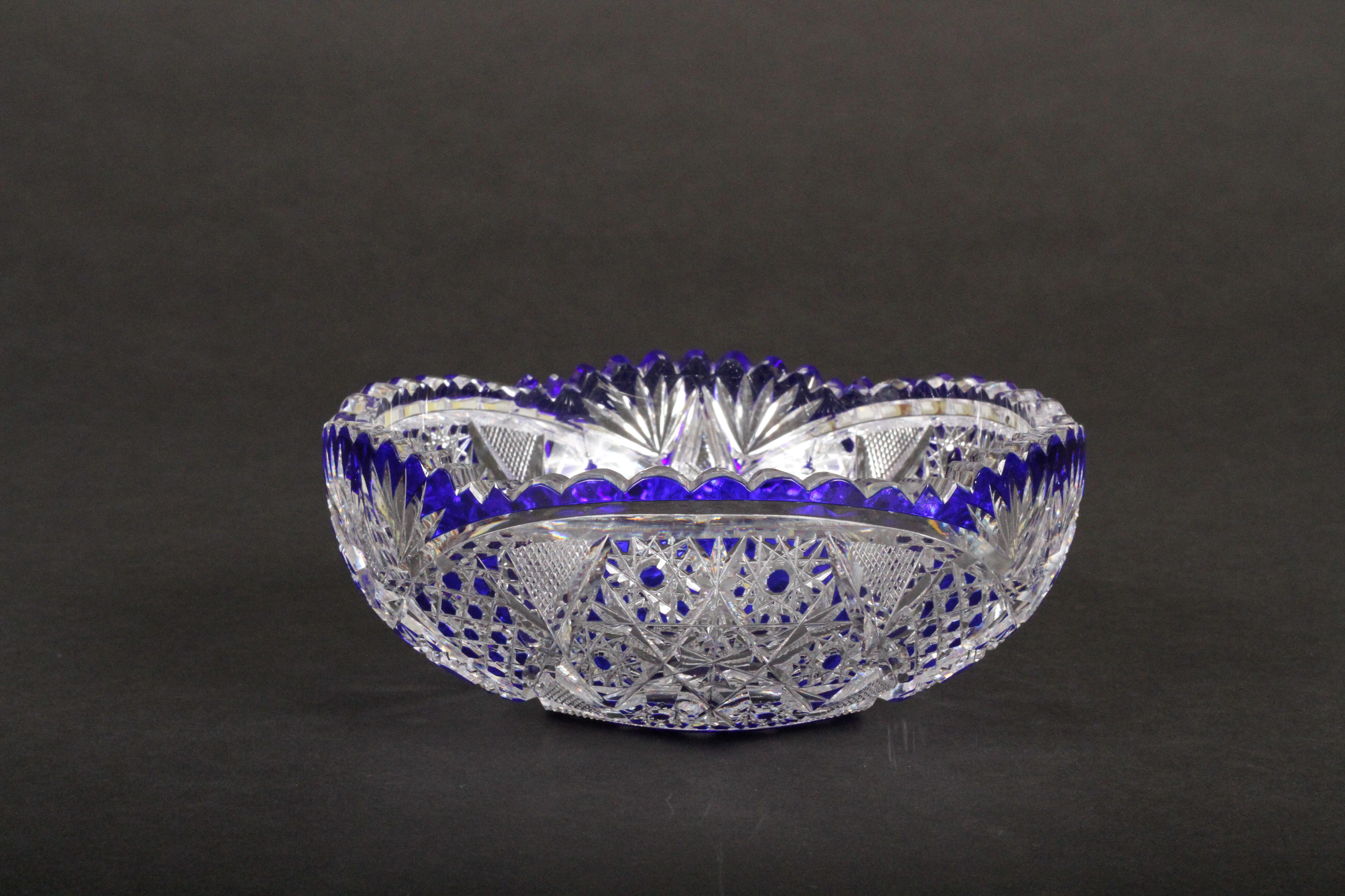 This wonderful cobalt blue cut-to-clear glass round bowl is from Cristalleries du Val Saint-Lambert, Belgium. This piece is hand blown and handcut. The geometric pattern features many deep cuts and cross-cuts that increase the brilliancy of the
