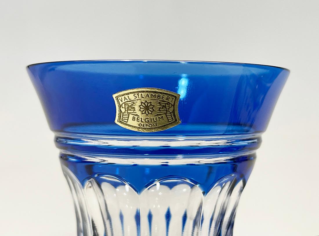 Val Saint Lambert cut-to clear small Crystal vases, Signed

A set of two small Belgium blue colored cut to clear crystal vases from Val Saint Lambert, Belgium, established since 1826. 
The vases are signed on the bottom and the vases have the paper