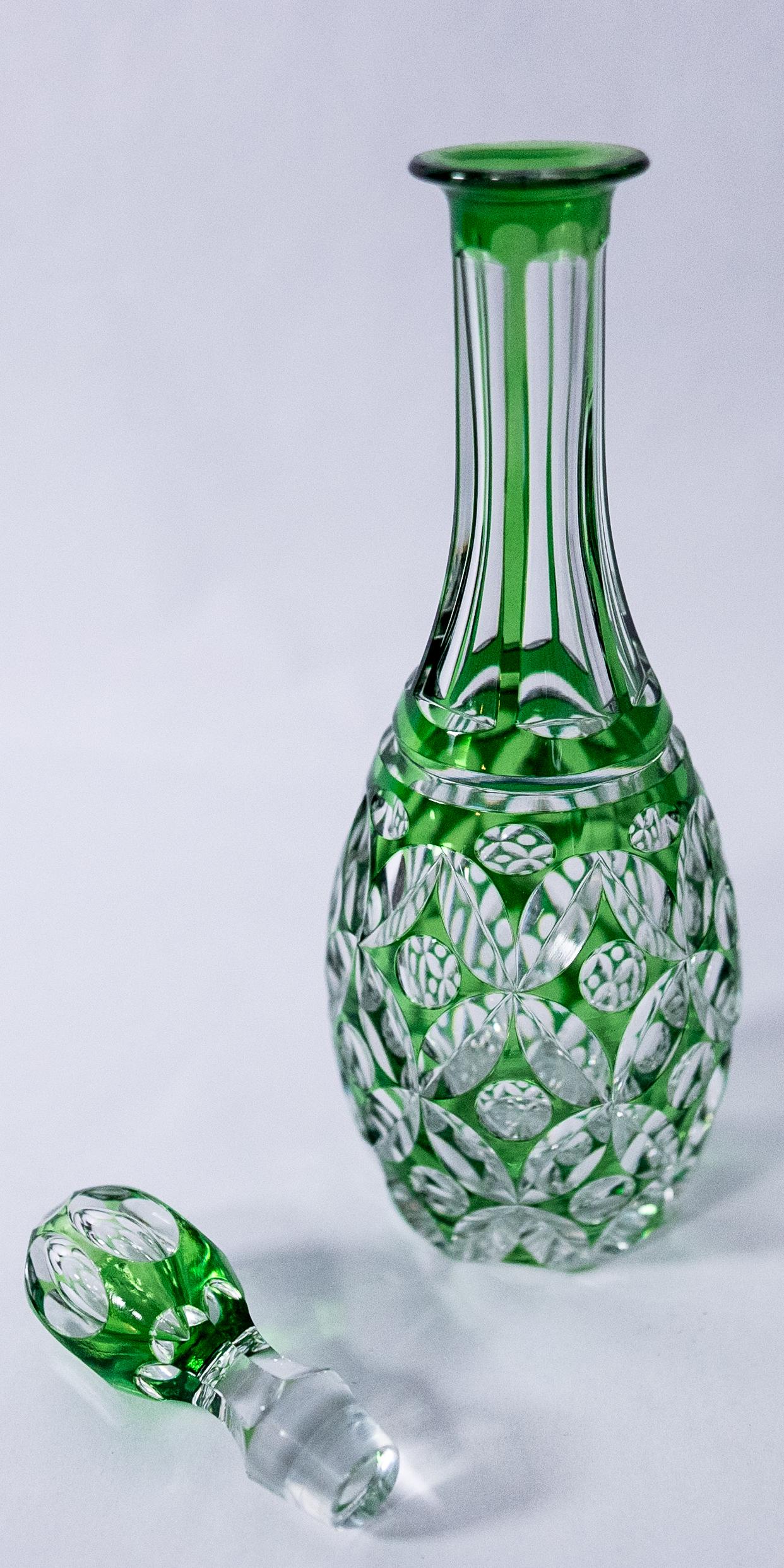 A vibrant green cased and cut to clear decanter by the storied Belgium crystal firm Val St Lambert. This decanter has great proportions and crisply cut design on body and its original stopper. In very nice antique condition and ready for your