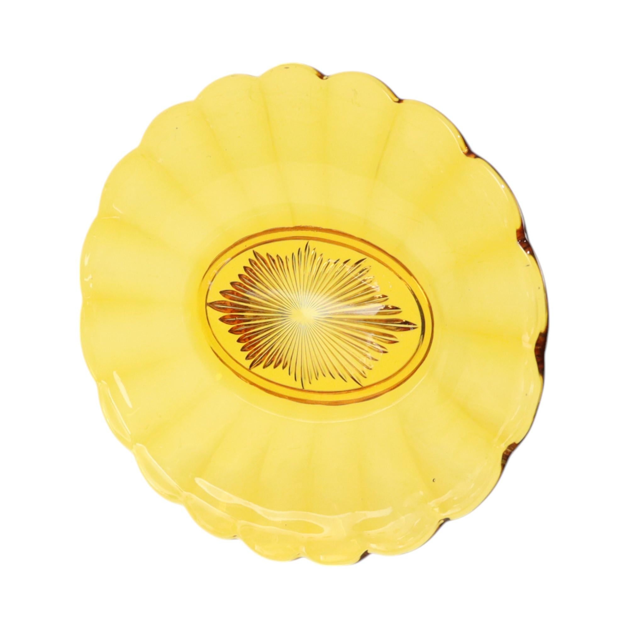 Beautiful amber-coloured pressed glass fruit bowl, very large bowl with a central rosette and rounded wavy edge, by Val Saint Lambert, the Luxval series from 1935, marked at the bottom.

This bowl comes from the Luxval series and can be seen in the