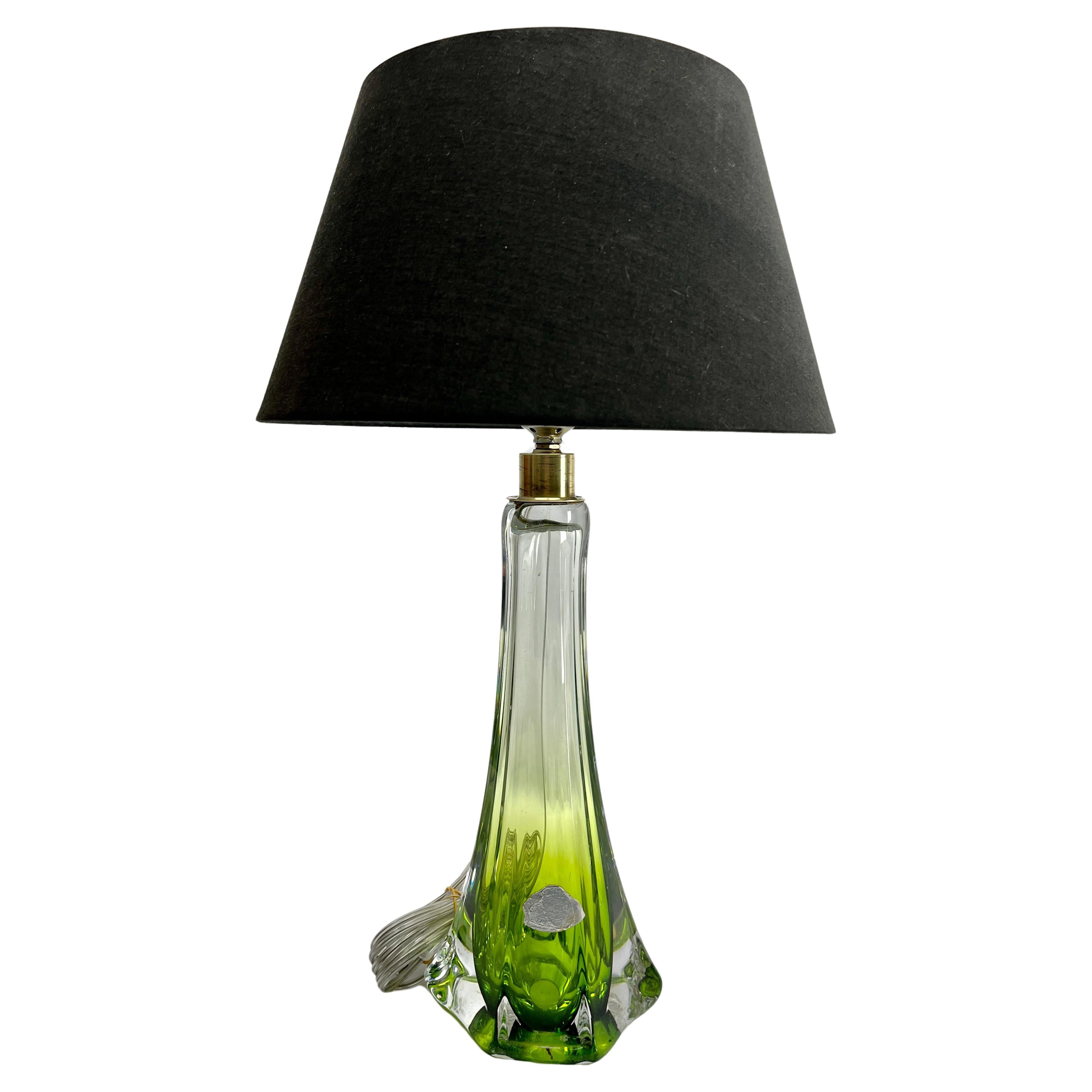 This simple yet graceful table lamp is in size; 39 cm excluding the shade.
The colored core in Classic Val Saint Lambert tint, has been given a thick Sommerso (clear crystal casing) so that the object appears delicate whilst remaining solid and