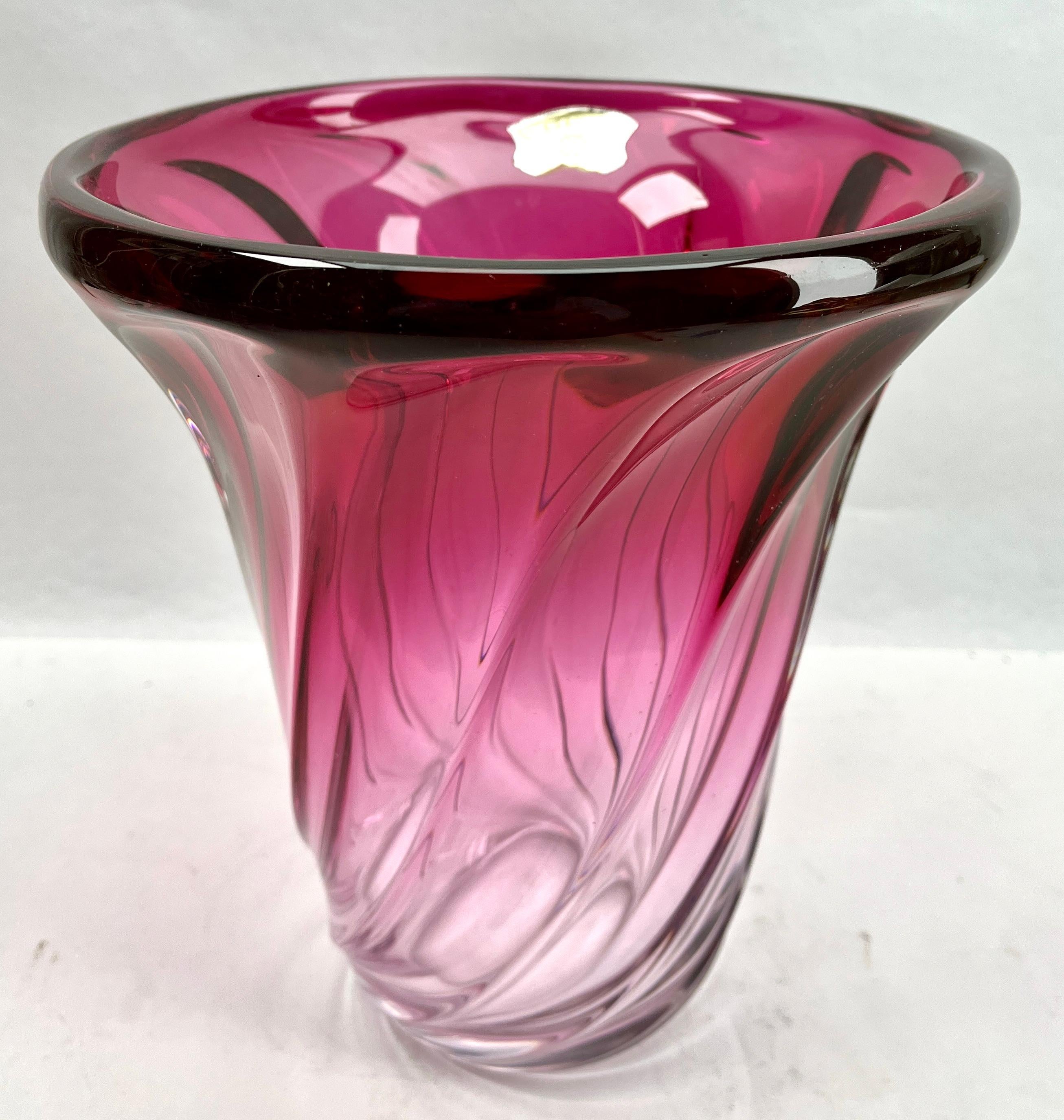 Val Saint Lambert, Label sculpted crystal vase with amethyst core, Belgium.

Heavy Val Saint Lambert crystal vase catalogued in the 1950s.
The central amethyst color (a traditional favorite for VSL) has been given a thick Sommerso (clear layer on
