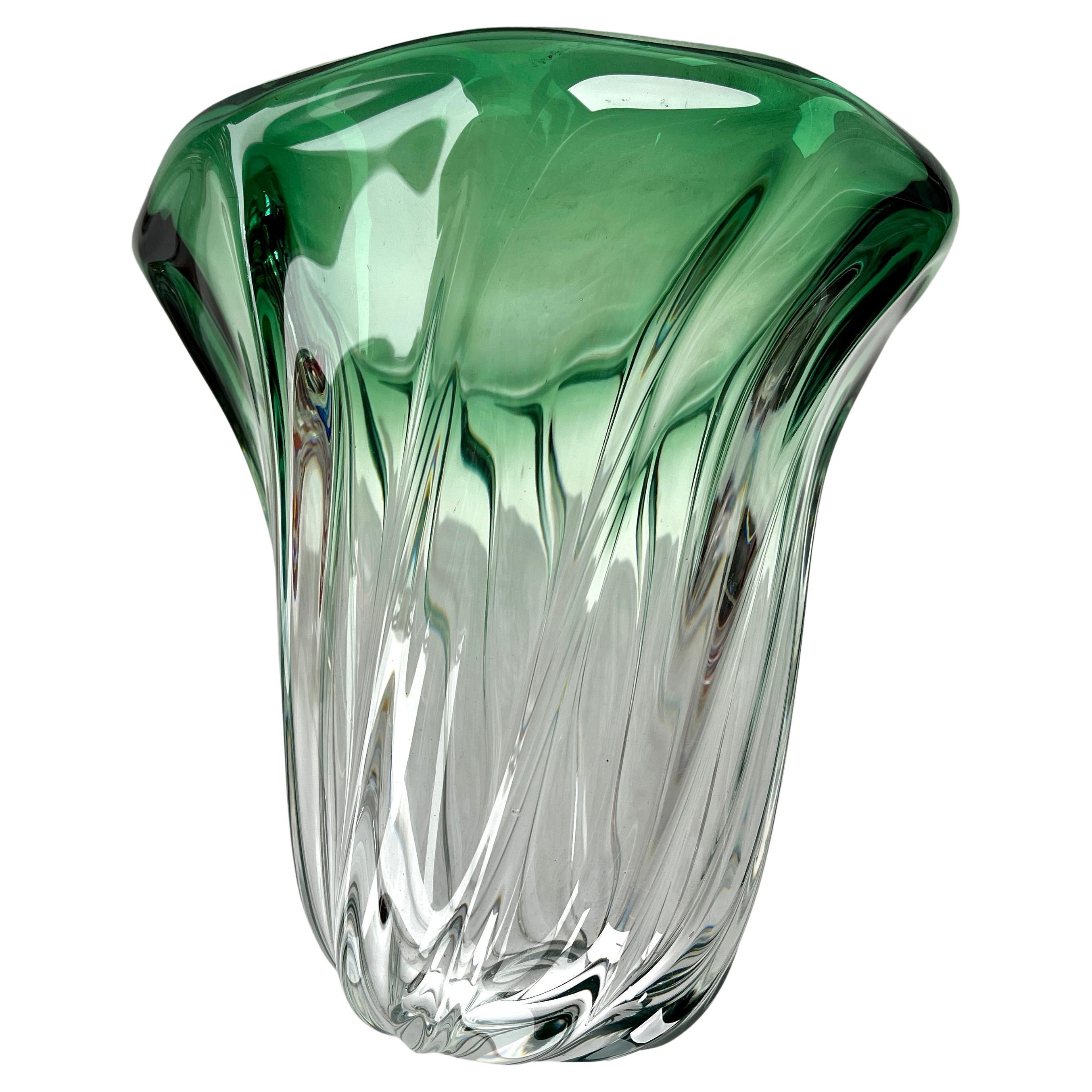 Val Saint Lambert, Label sculpted crystal vase with Green core, Belgium.

Heavy Val Saint Lambert crystal vase catalogued in the 1950s.
The central amethyst color (a traditional favorite for VSL) has been given a thick Sommerso (clear layer on the