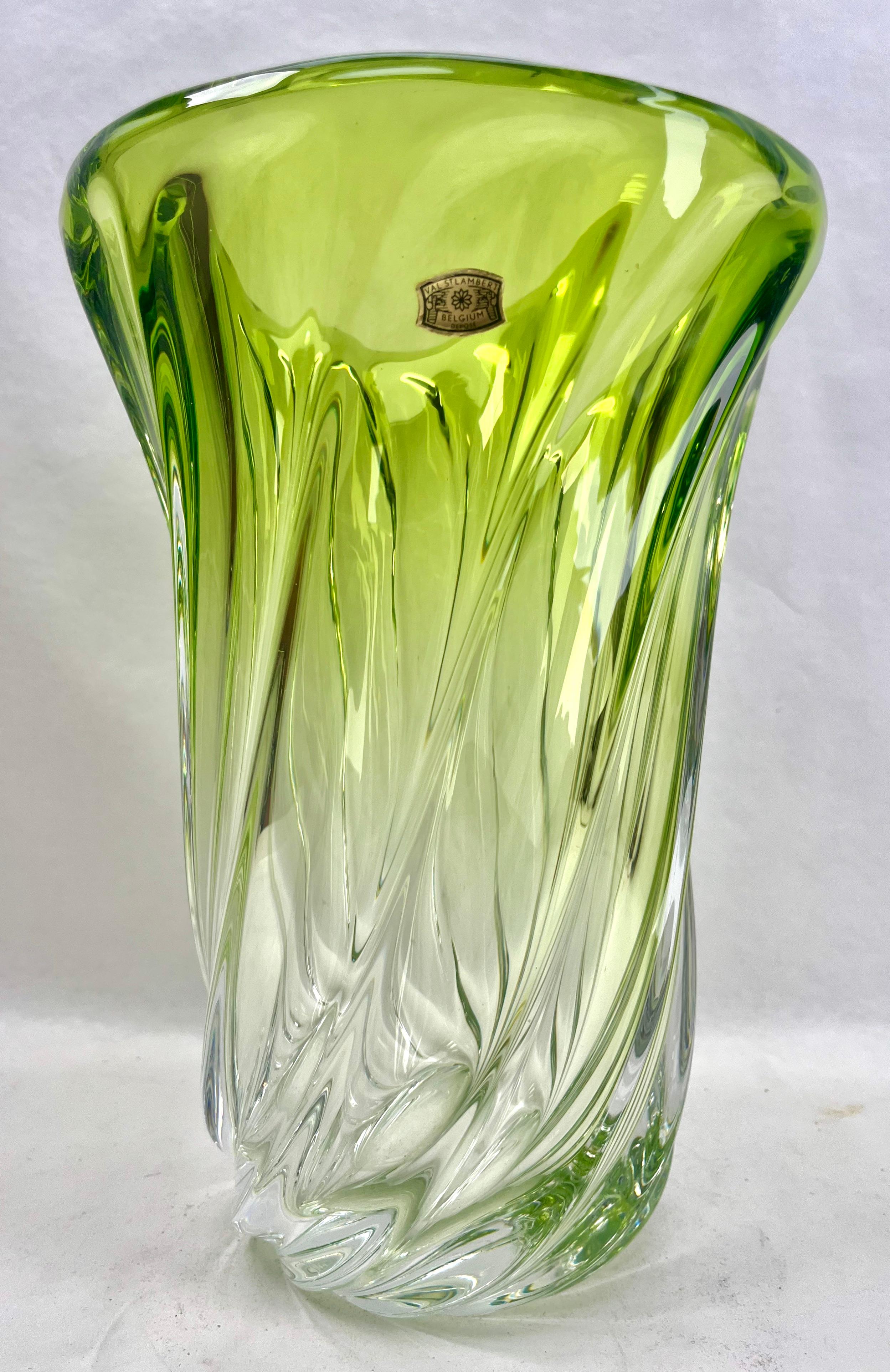 Val Saint Lambert, LABEL  sculpted crystal vase with Green core, Belgium.

Heavy Val Saint Lambert crystal vase catalogued in the 1950s.
The central amethyst color (a traditional favorite for VSL) has been given a thick Sommerso (clear layer on the