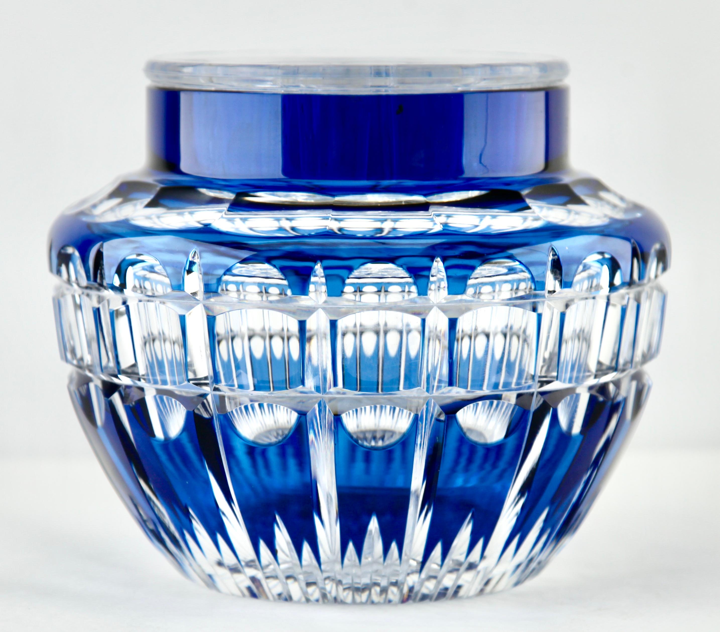 Large vibrant, Cobalt Bleu cased-crystal glass 'Pique Fleurs' vase with a cut-to-clear Art Deco decoration 
This design for vases is often called 'Pique fleurs' or 'rose-bowl' and is supplied with a fitted crystal grille to support stems in an
