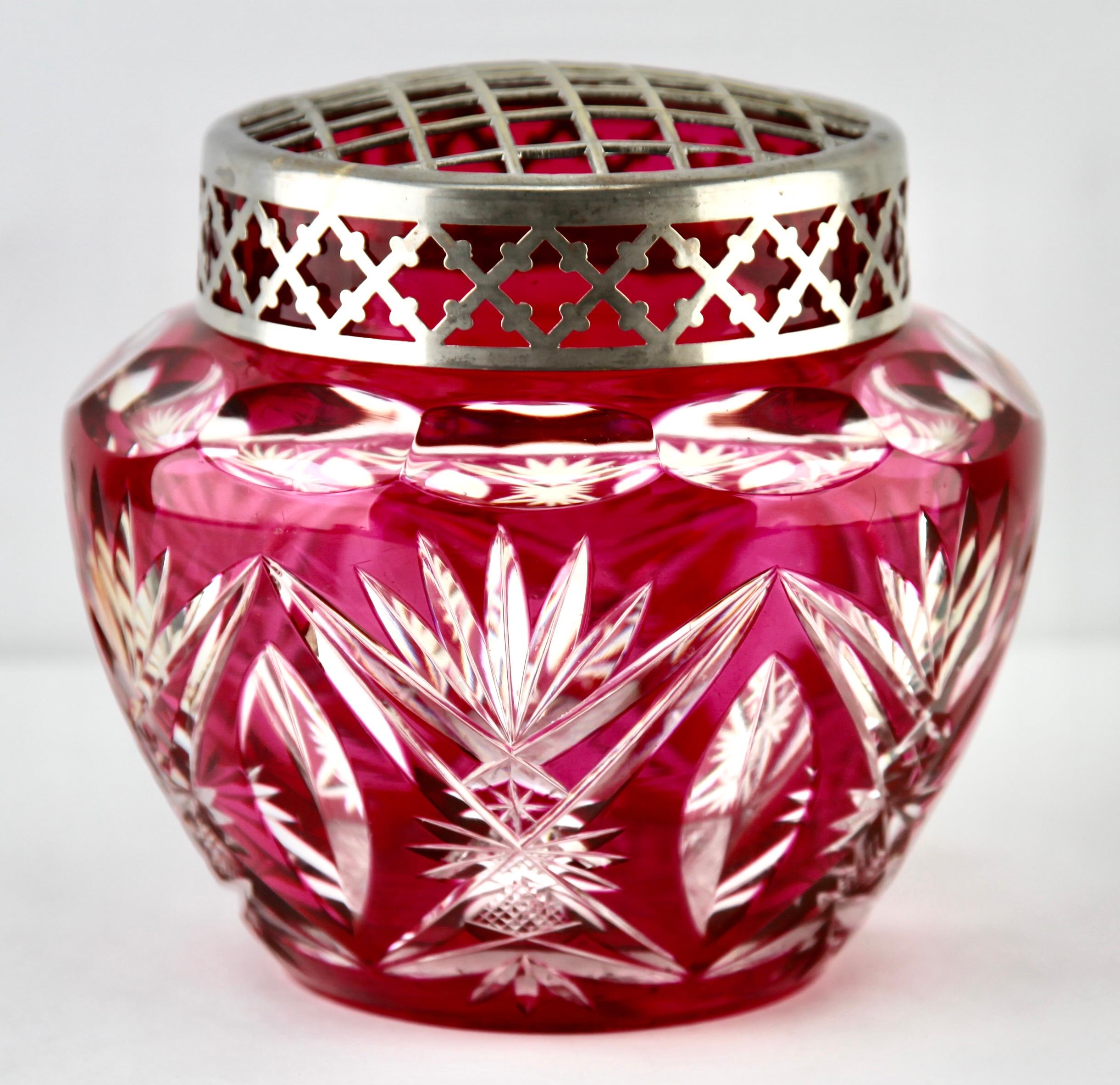 Vibrant, cased-crystal glass 'Pique Fleurs' vase with a cut-to-clear Art Deco decoration 
This design for vases is often called 'Pique fleurs' or 'rose-bowl' and is supplied with a fitted crystal grille to support stems in an arrangement. The body