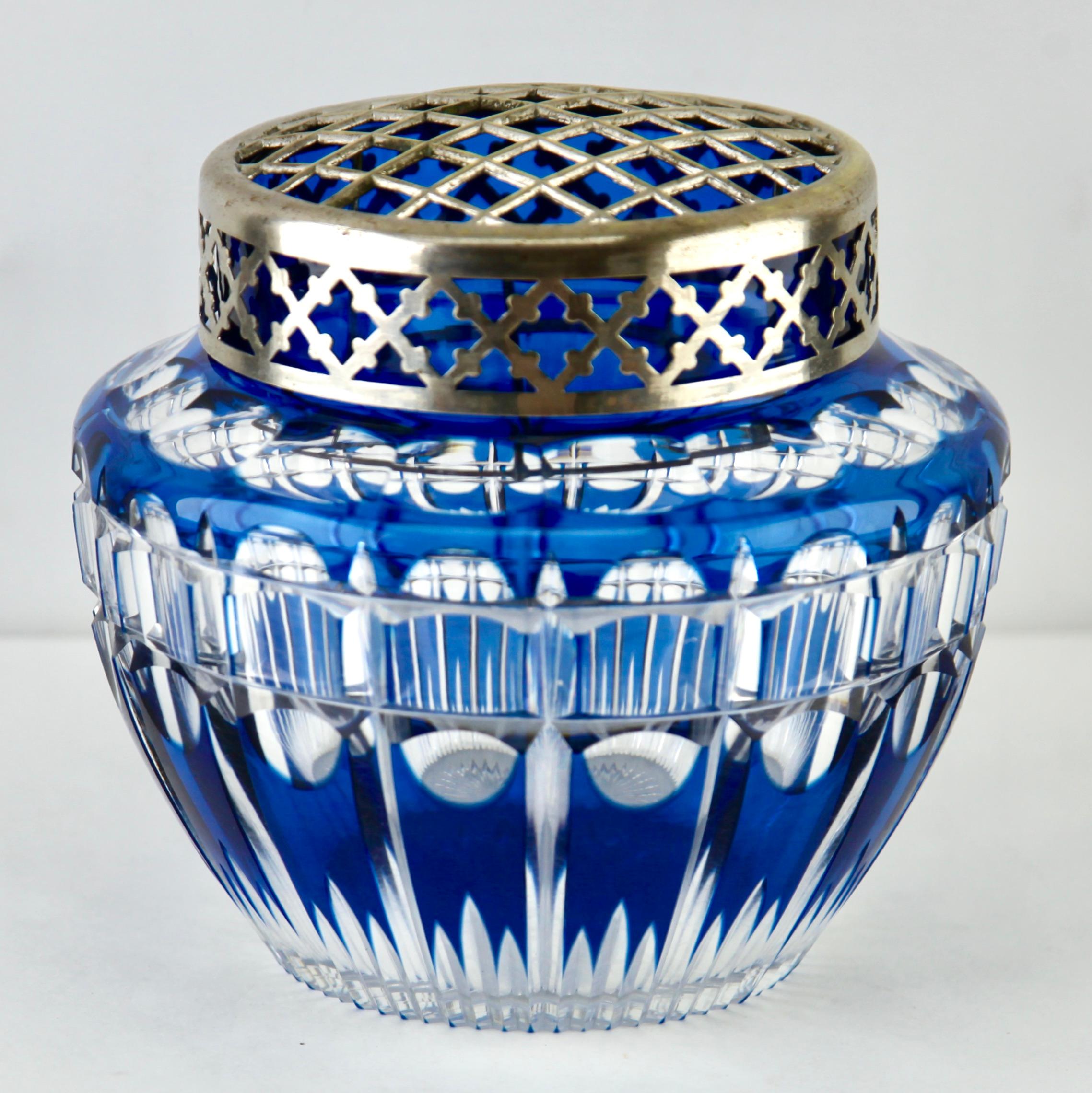 Vibrant, cobalt bleu cased-crystal glass 'Pique Fleurs' vase with a cut-to-clear Art Deco decoration
This design for vases is often called 'Pique fleurs' or 'rose-bowl' and is supplied with a fitted crystal grille to support stems in an