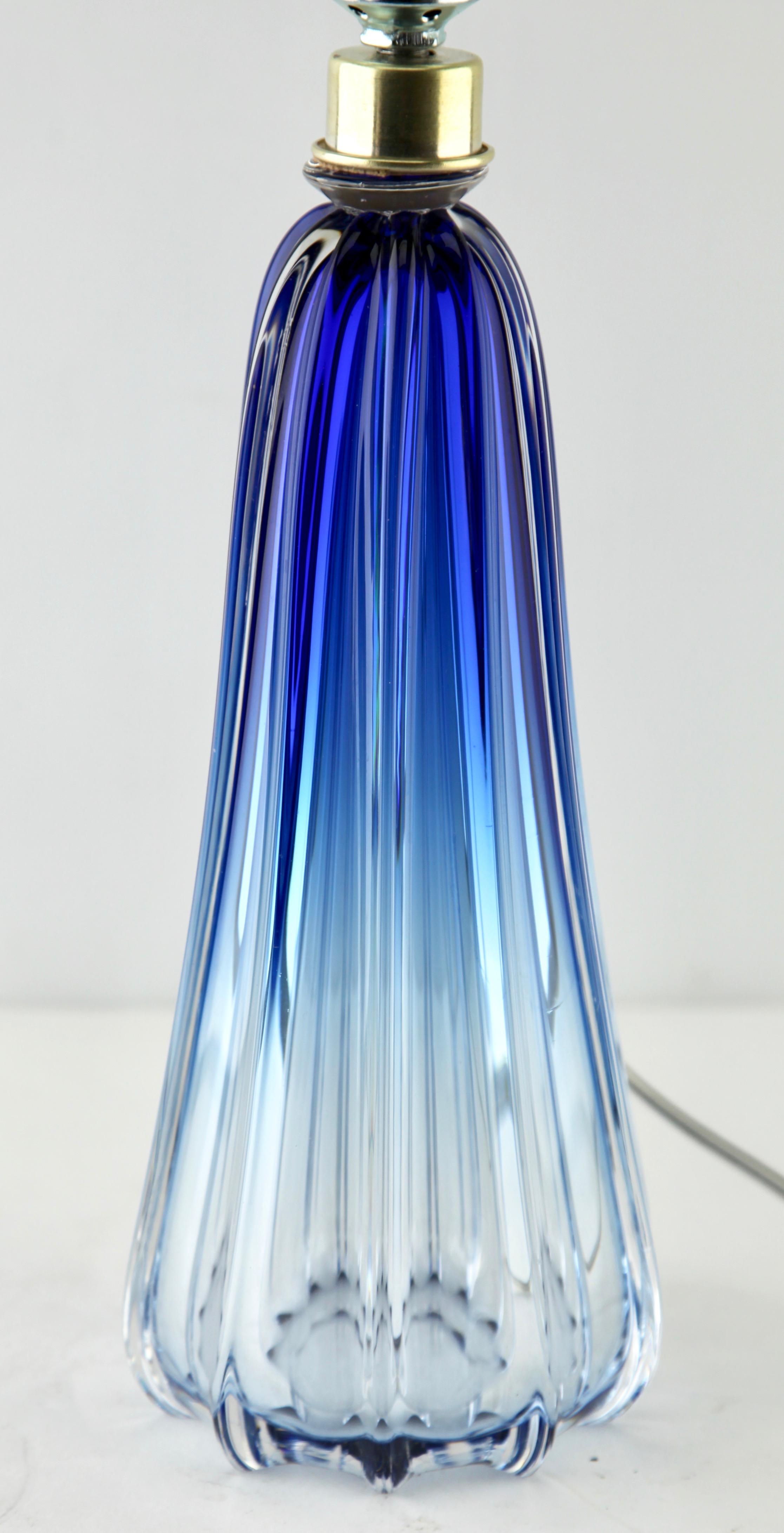This simple yet graceful table lamp is in large size; 12.99 inches excluding the shade.
The colored core in Classic Val Saint Lambert tint, has been given a thick Sommerso (clear crystal casing) so that the object appears delicate whilst remaining