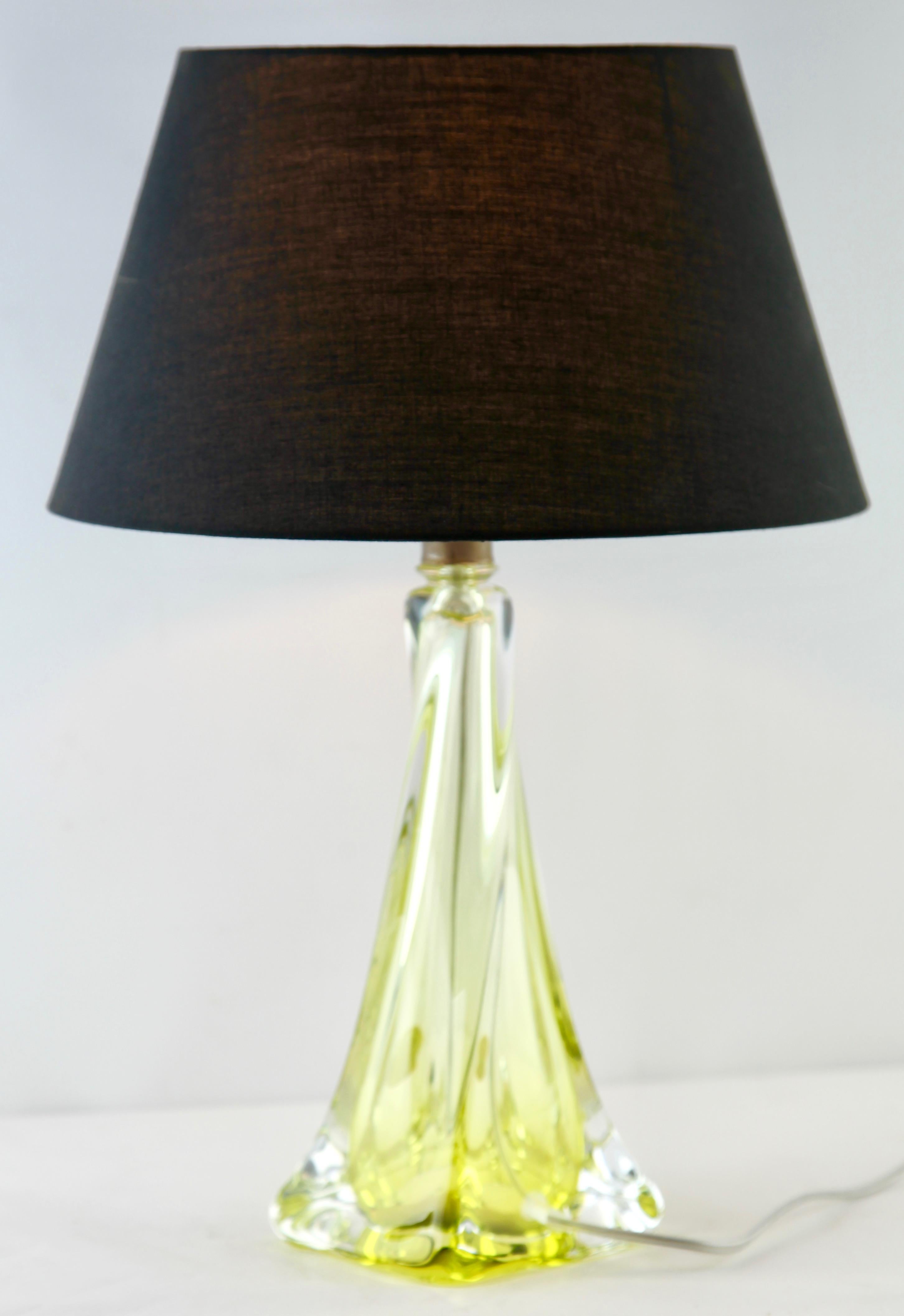 This simple yet graceful table lamp is in large size; 15 inches excluding the lamp-fitting and shade.
The colored core in Classic Val Saint Lambert tint, has been given a thick Sommerso (clear crystal casing) so that the object appears delicate