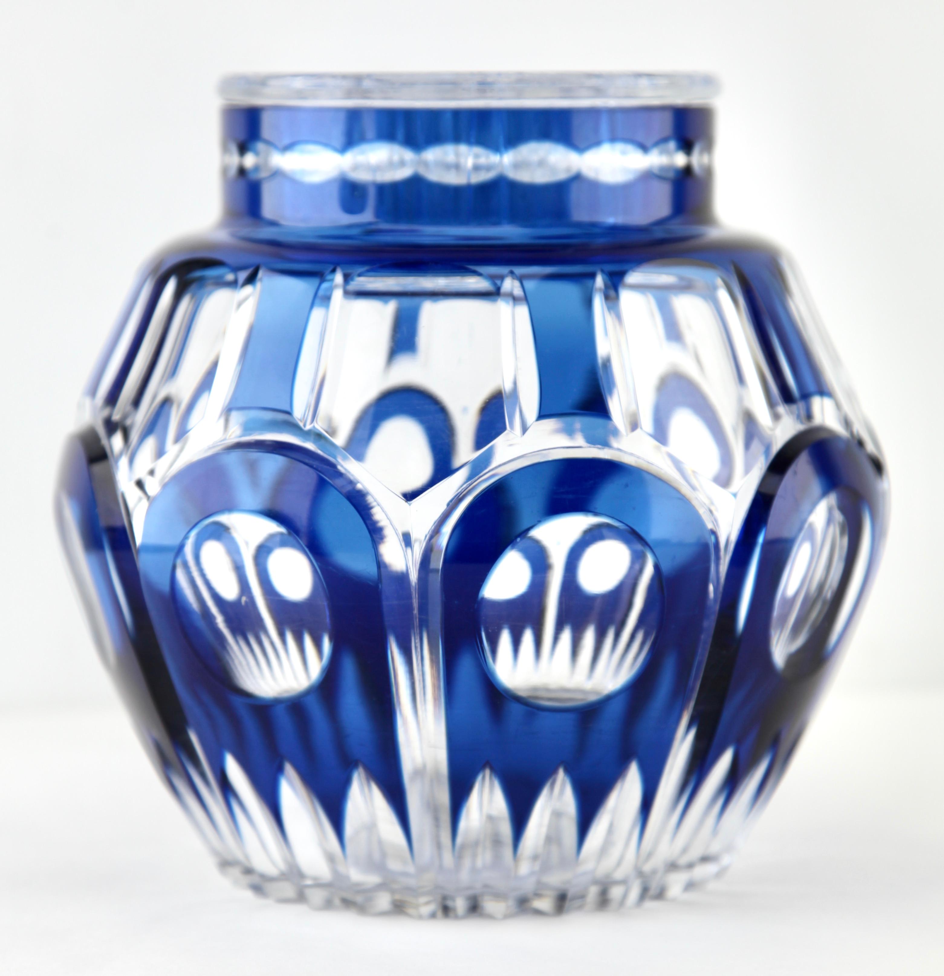Large vibrant, Cobalt Bleu cased-crystal glass 'Pique Fleurs' vase with a cut-to-clear Art Deco decoration 
This design for vases is often called 'Pique fleurs' or 'rose-bowl' and is supplied with a fitted crystal grille to support stems in an