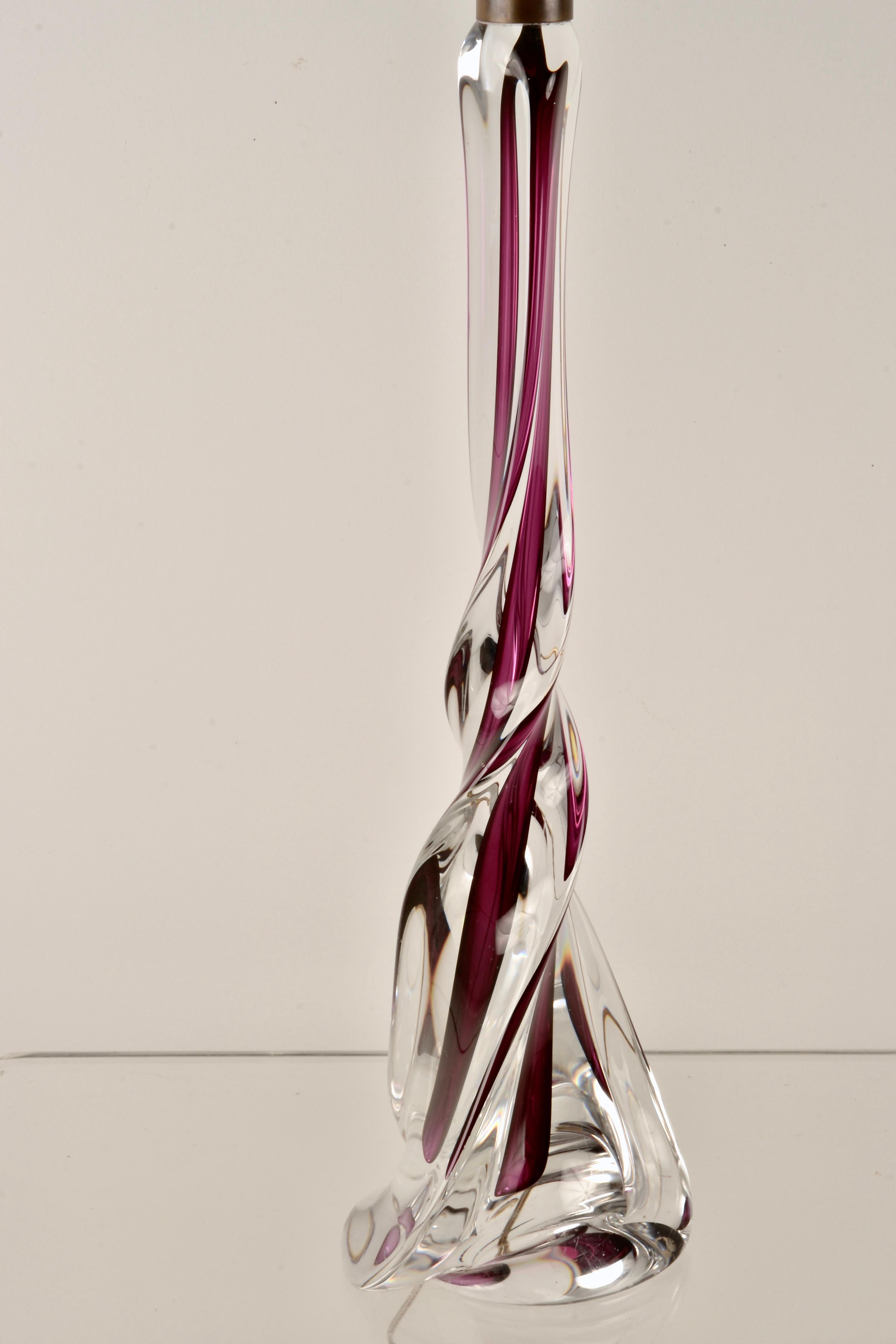 An unusually tall example of the elegant glass table lamps by Belgian glassworks, Val Saint Lambert. Featuring hand blown-glass crafted into twisted cased glass in clear and ruby. Custom lamp fittings are brass. Base is signed and numbered. Very