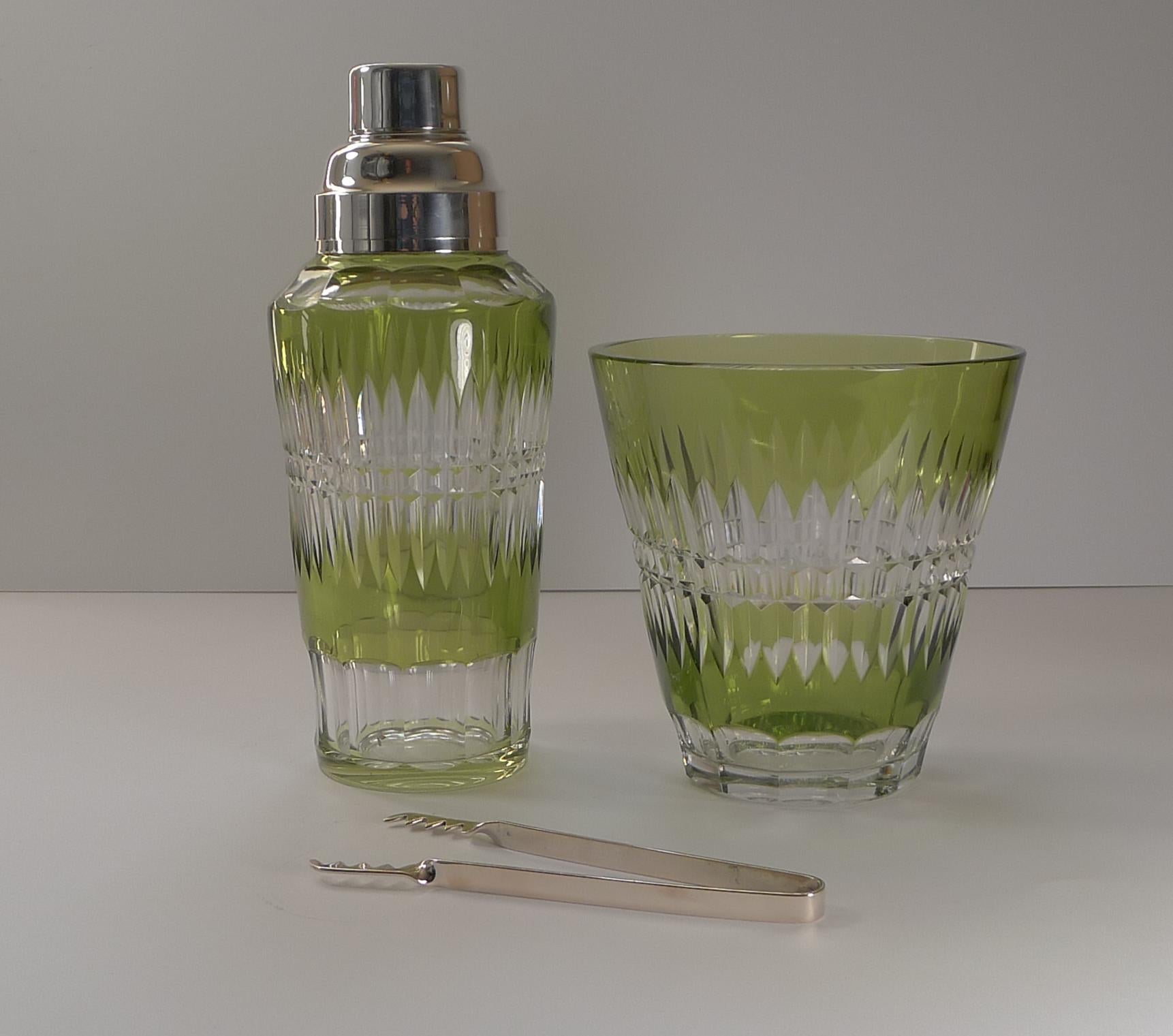 Fabulous to find a matching set made by top notch Belgian maker, Val St Lambert. 

Made from heavy crystal in Olive Green to Clear, the underside of the ice bucket has the famous Val St Lambert signature. The cocktail shaker is unmarked on the