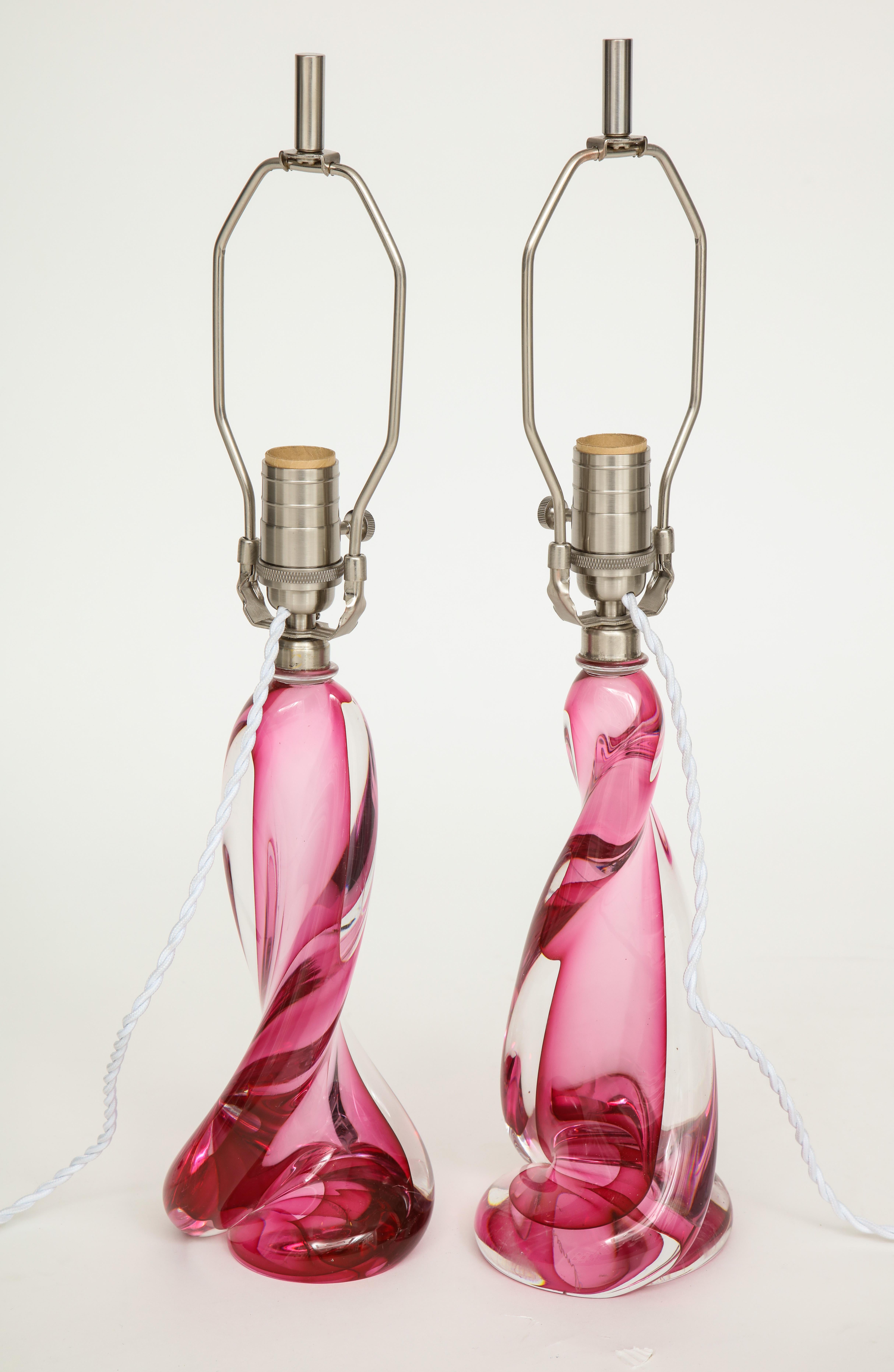 Pair of modernist twist form crystal lamps featuring pink hued and clear crystal. Rewired for use in the USA.