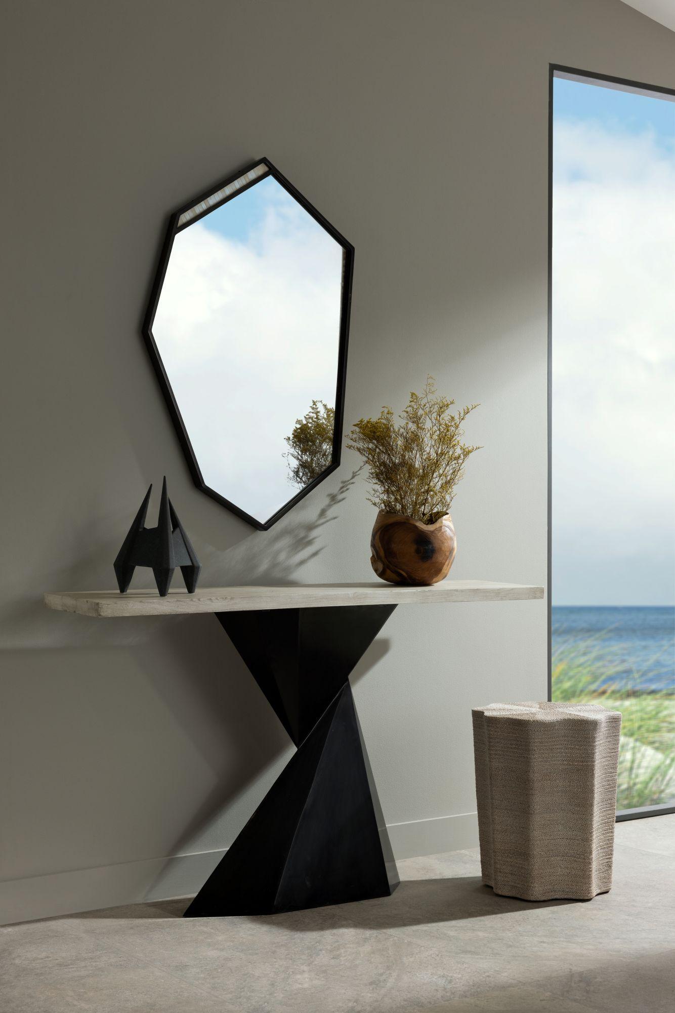 Sleek, sculptural, and undeniably modern, the Valder Console takes its inspiration from the precise folds of origami, translating that artistry into a bold furniture statement. The pedestal base is crafted from blackened-bronze iron and designed
