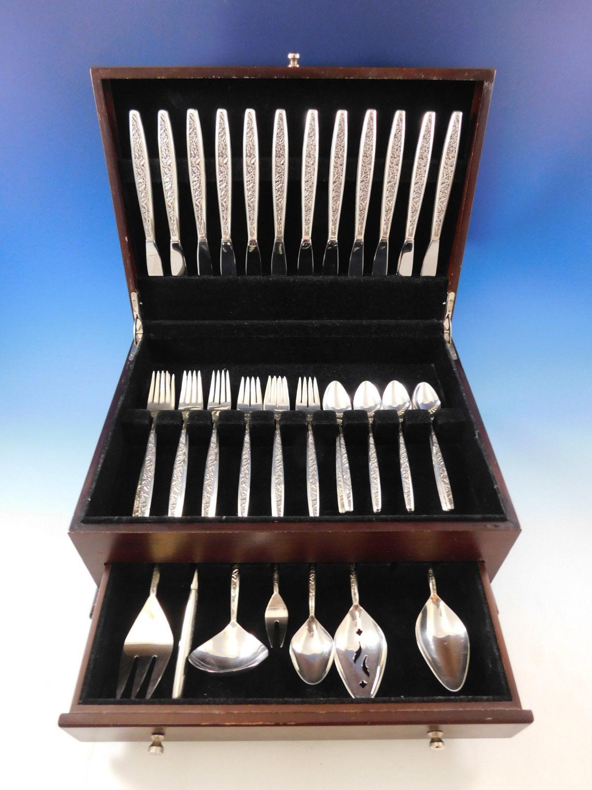 Superb Valencia by International sterling silver flatware set, 55 pieces. The Valencia pattern was introduced in the year 1964 and features a contemporary elongated handle with an all-over decorative floral and leaf pattern on the front. This set