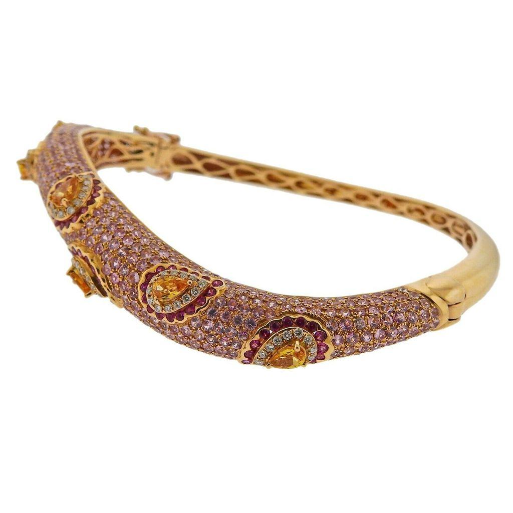 Valente 18k rose gold wave bangle bracelet, set with 10.89ctw in pink sapphires and vitrines, as well as 0.52ctw in G/VS diamonds. Bracelet will fit approx. 7.5-8