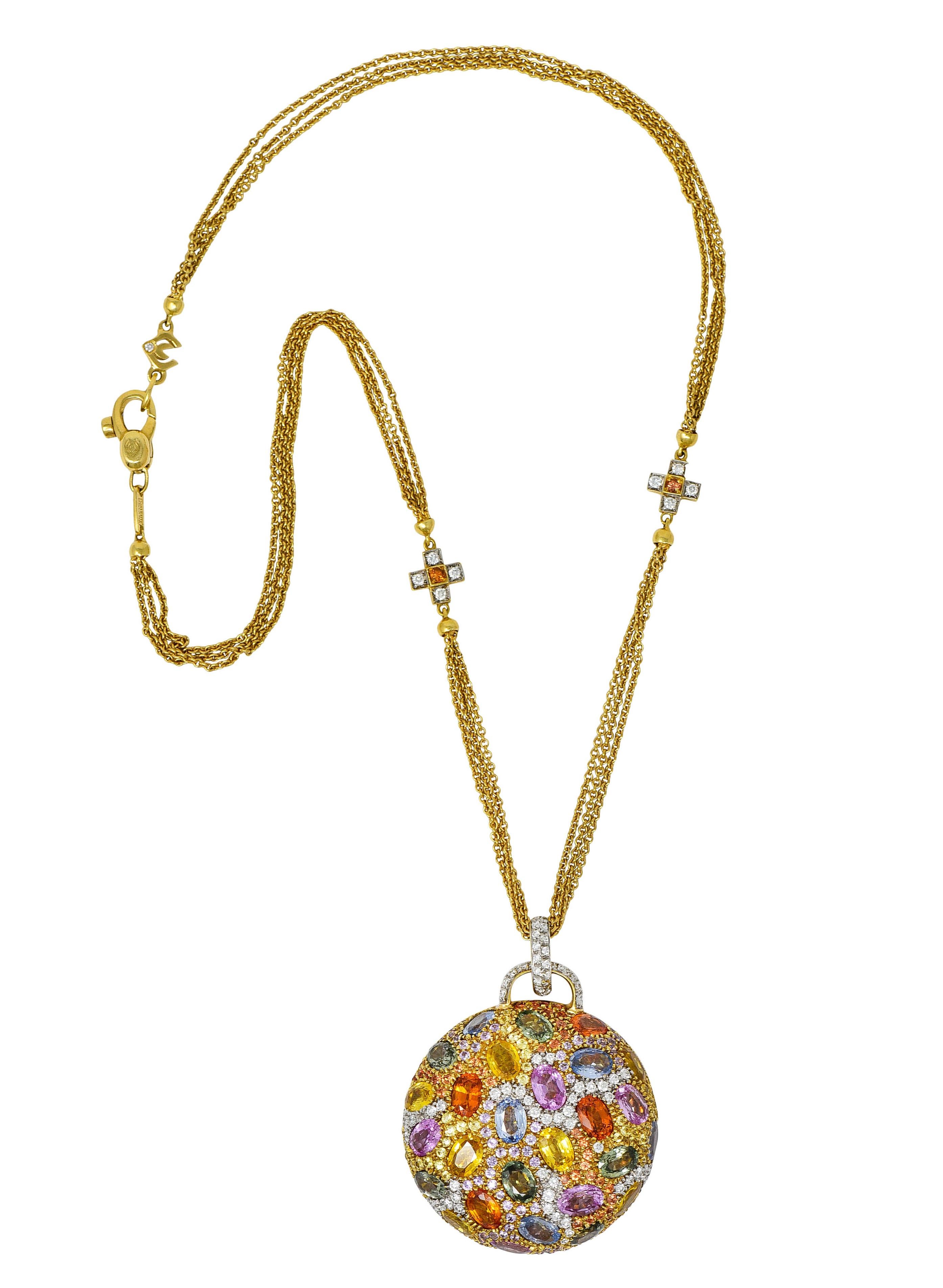 Multi-strand necklace is accented by two cross motif stations and completes as a lobster clasp with logo links

Circular pendant is pavè set throughout by colorful sapphires and round brilliant cut diamonds

Oval cut sapphires weigh in total
