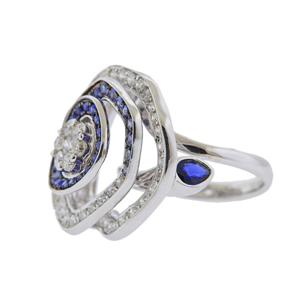 18k gold ring crafted by Valente. Ring features 1.44ctw in VS GH diamonds, and 0.86 ctw in sapphires. Ring size - 7.25, ring top - 25mm x 25mm. Total weight 14.4 grams. Marked Valente, Italian mark, 750.

