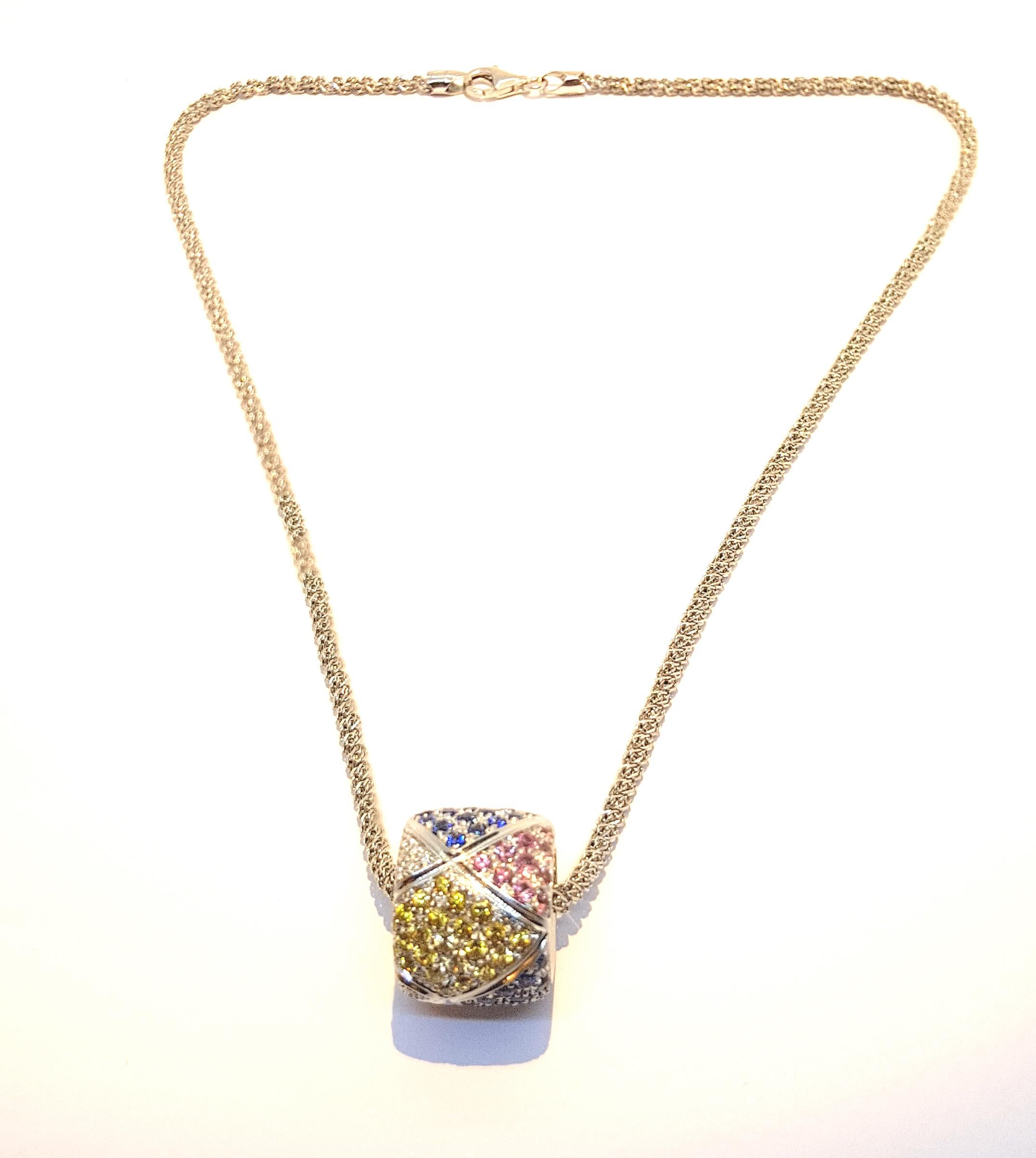 A rainbow dance of multicolored sapphires blue, pink and yellow 93 pieces of .02ct total 18.6ct of saphires
and total 3.45ct of diamonds 
The  18k white gold pendant Weights 15.9gr 
Options of chains are upon request.  The chain in the picture is