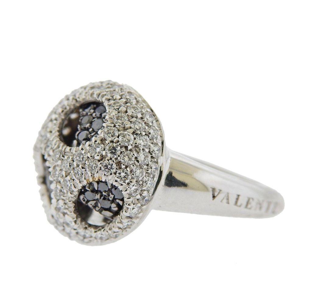 18k gold ring crafted by Valente. Ring features 1.42ctw in VS GH diamonds, and black diamonds. Ring size - 7.25, ring top - 17mm in diameter. Total weight 9.7 grams. Marked Valente, Italian mark, 750.

