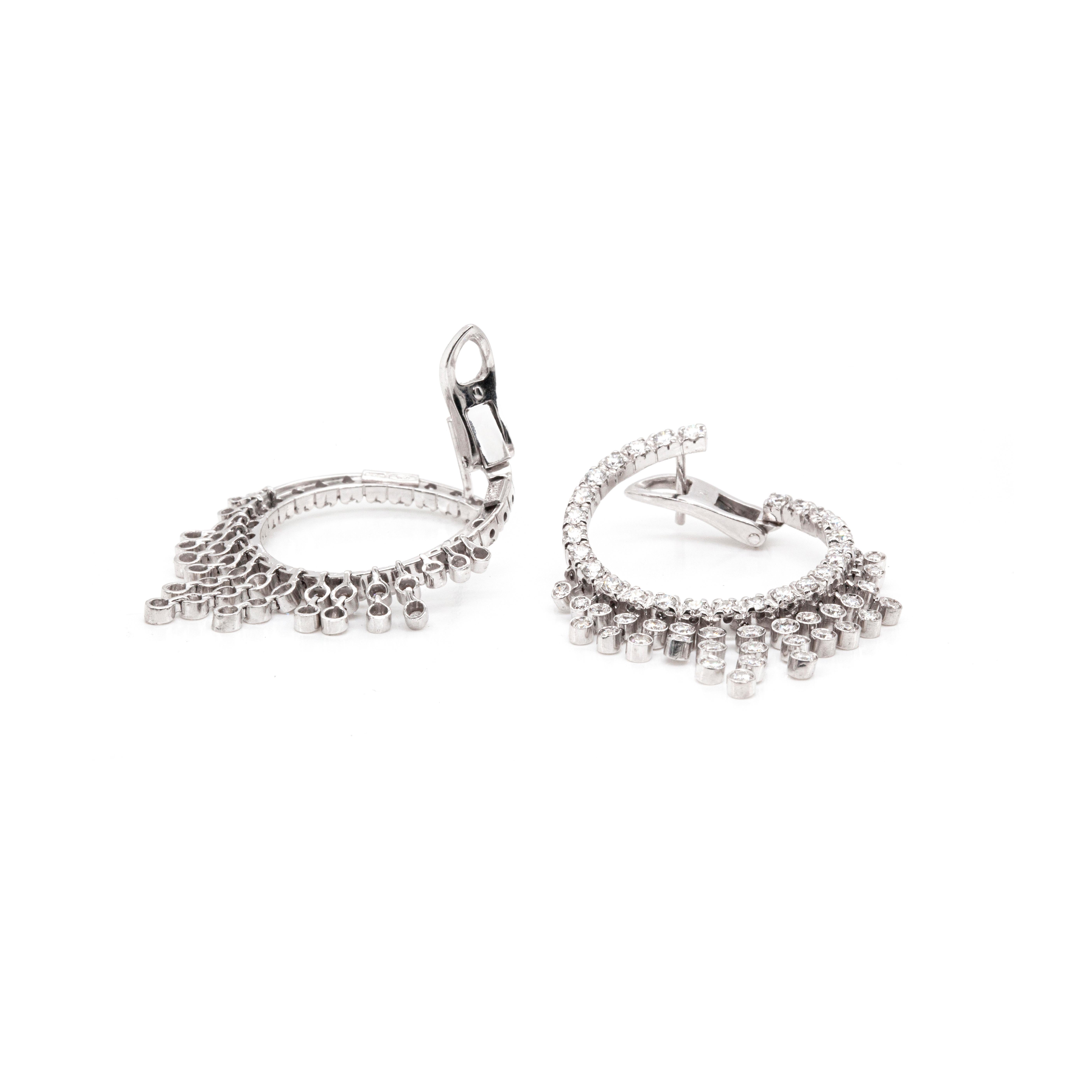 These gorgeous Valente Milano earrings are a beautiful twist on classic diamond-set hoops, balancing sparkle with elegance. Designed to sit side-on (as opposed to traditional front to back hoops), all of the scintillating high quality diamonds are