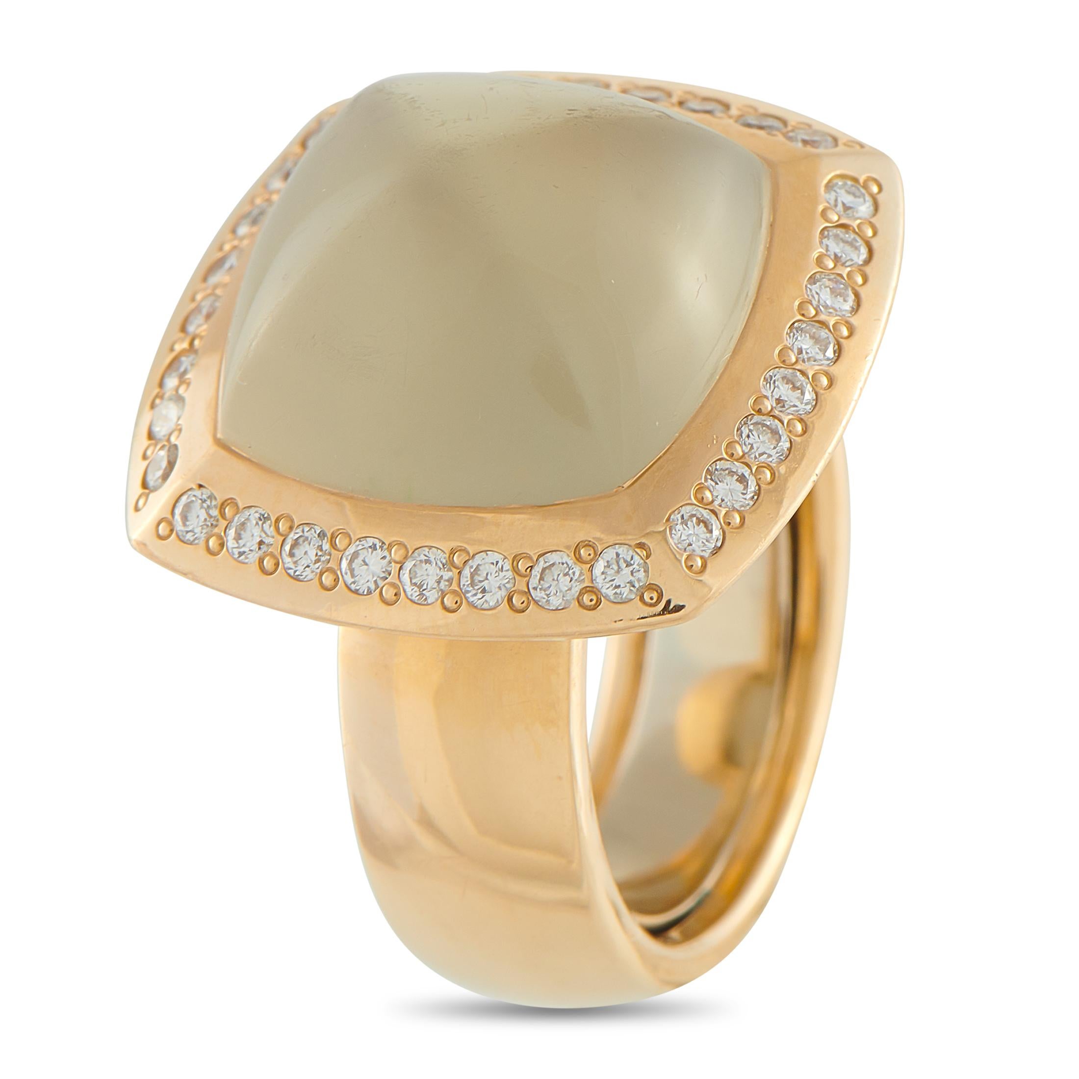 At the center of this ring sits a smooth, sugarloaf cabochon of smoky quartz, its translucent glow perfectly complemented by the 18K yellow gold setting. Delicate white diamonds trace the cushion-shaped halo that frames the gemstone. The 8mm wide