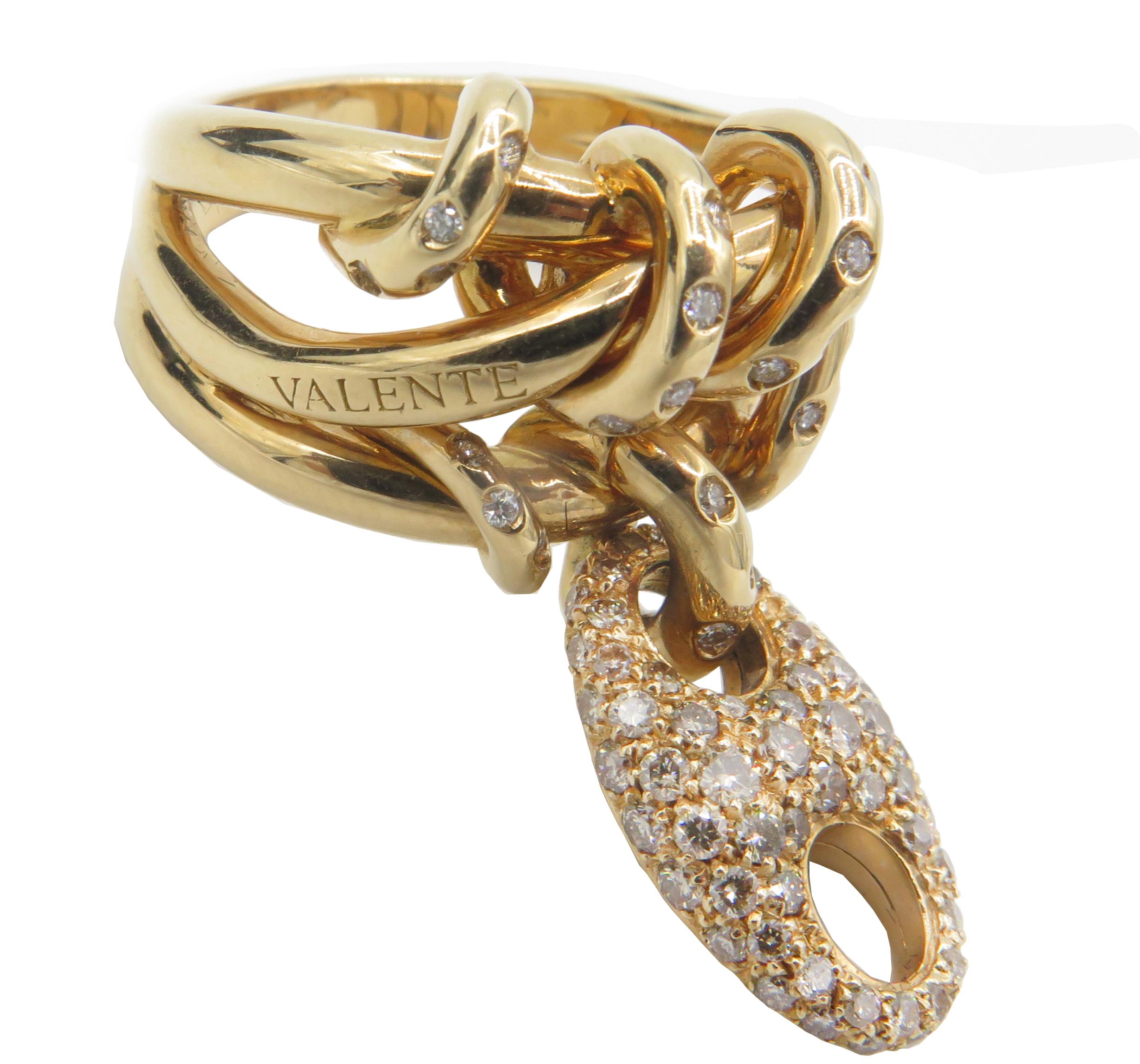 This is remarkably beautiful 18k yellow gold ring from Valente Milano, designed by John Galliano. The golden sculptural curls and designs of the ring are studded with round, brilliant white diamonds. An 18k yellow gold signature Valente charm,