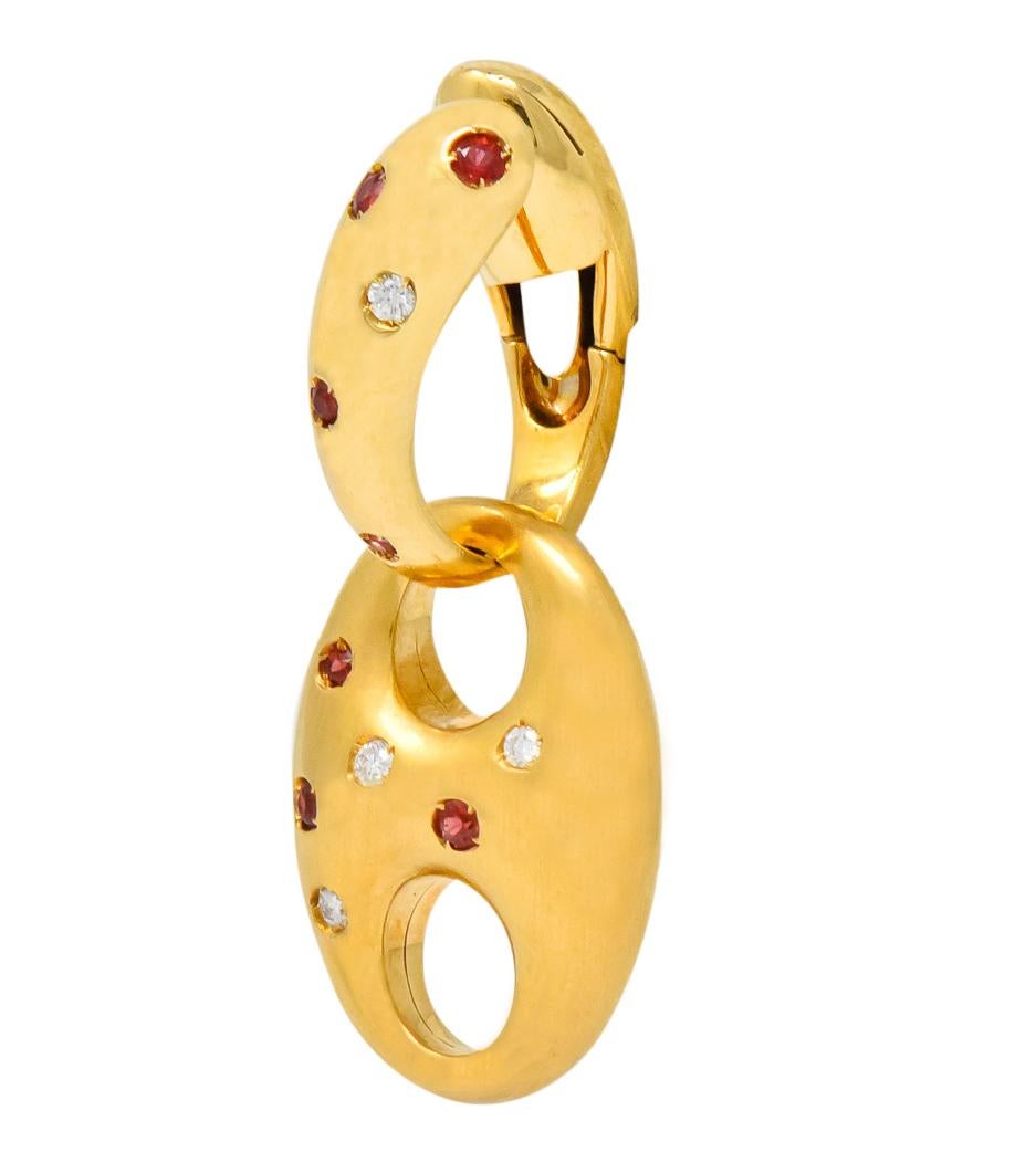 Each designed as a polished huggie with a large matte finished mariner link drop, flush set with rubies and diamonds

Rubies are round cut and weigh approximately 0.40 carat total, transparent and a bright orangey-red color

Diamonds are round cut