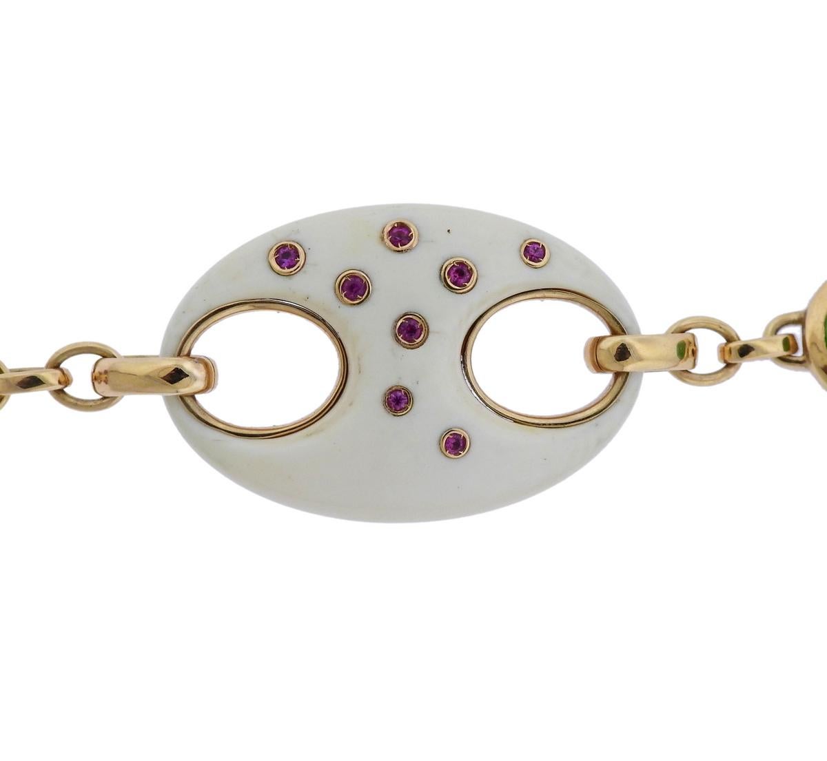 18k gold link bracelet, designed by Valente, featuring pink sapphires, ebony, peridot cabochon and approx. 0.08ctw in diamonds.  Bracelet is 9.5