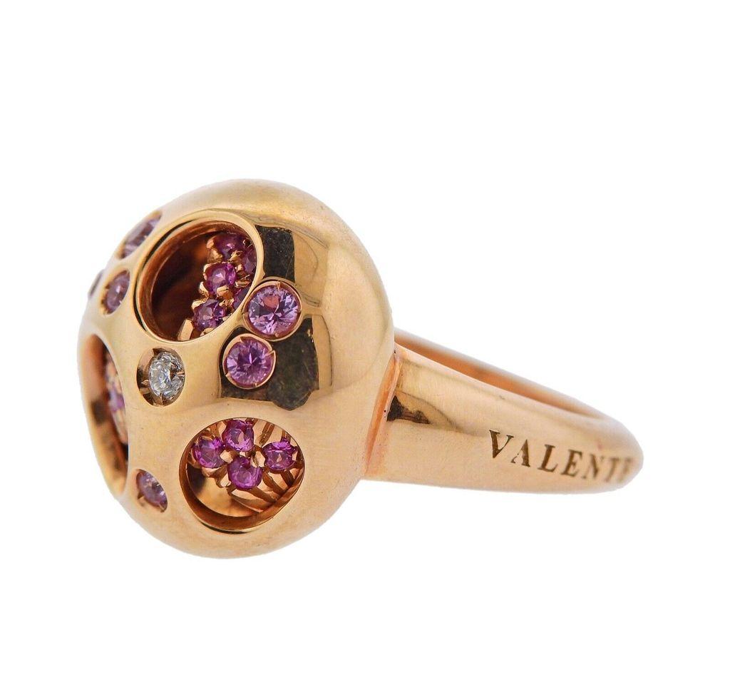 18k gold ring crafted by Valente. Ring features 0.05ctw in VS GH diamonds, and 0.50 ctw in pink sapphires. Ring size - 7.25, ring top - 17mm in diameter. Total weight 13 grams. Marked Valente, Italian mark, 750.

