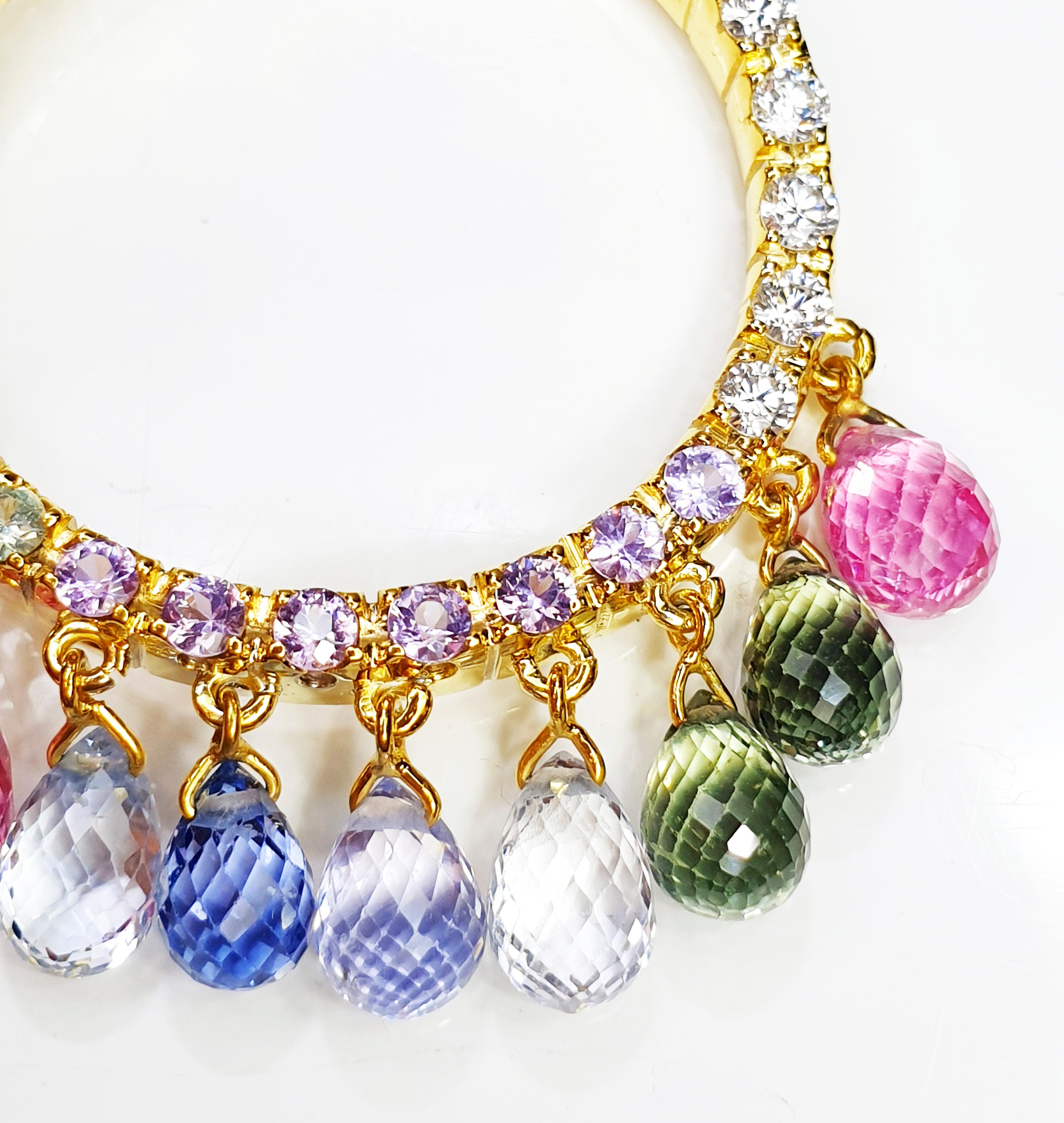 Yellow 18k gold Necklace and charm with diamond and multicoloured briolle faceted saphires
Shirasi Collection romance, elegance, and orient touches. Valente was founded in Milan in 1953 by Tranquillo Valente.   
Gold grams 12gr
Diamonds