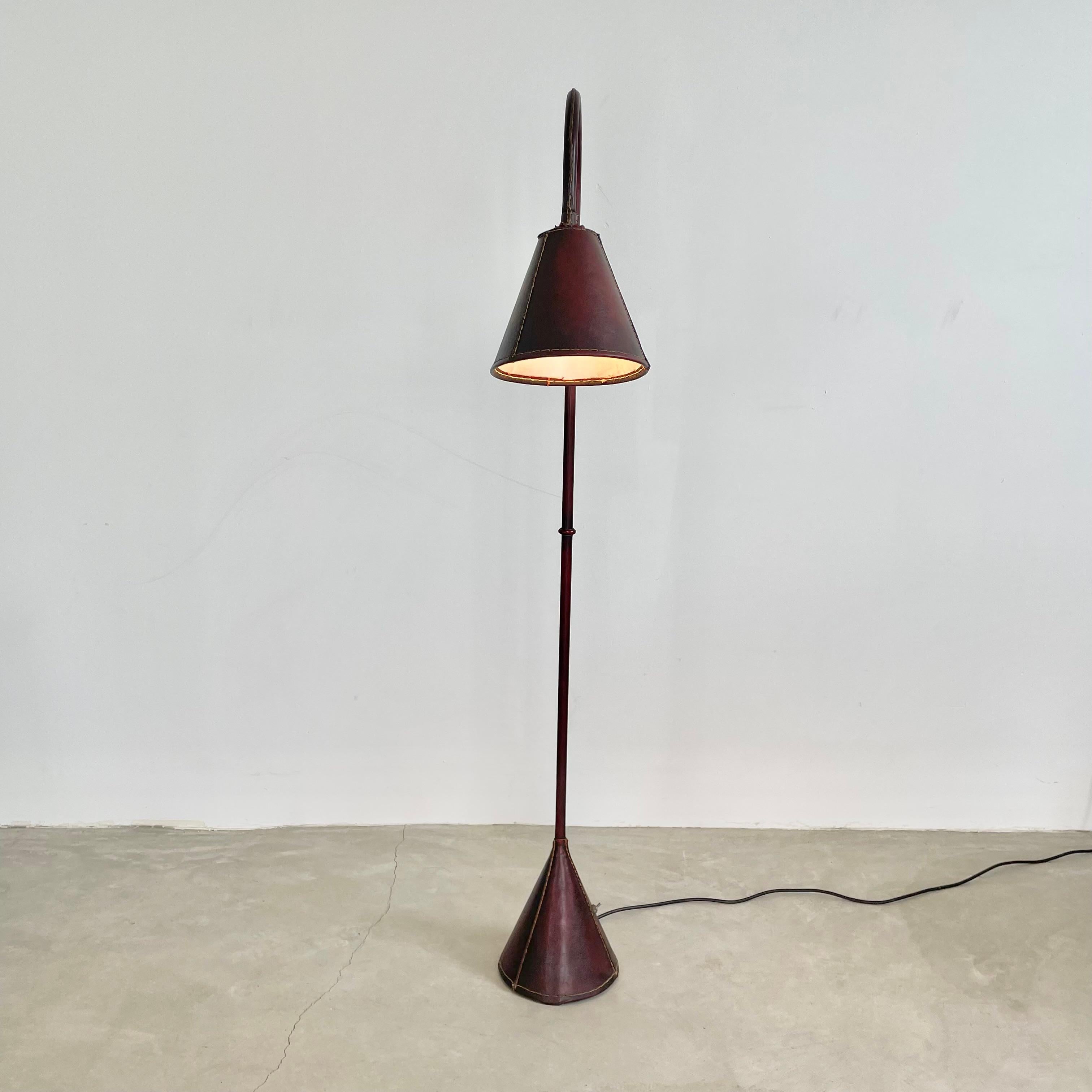 Handsome leather arched floor lamp by Spanish design house, Valenti. Based in Barcelona and founded over 200 years ago, Valenti has deep roots in high end furniture and elegant designs. Made in the 1970s this floor lamp is completely wrapped in a