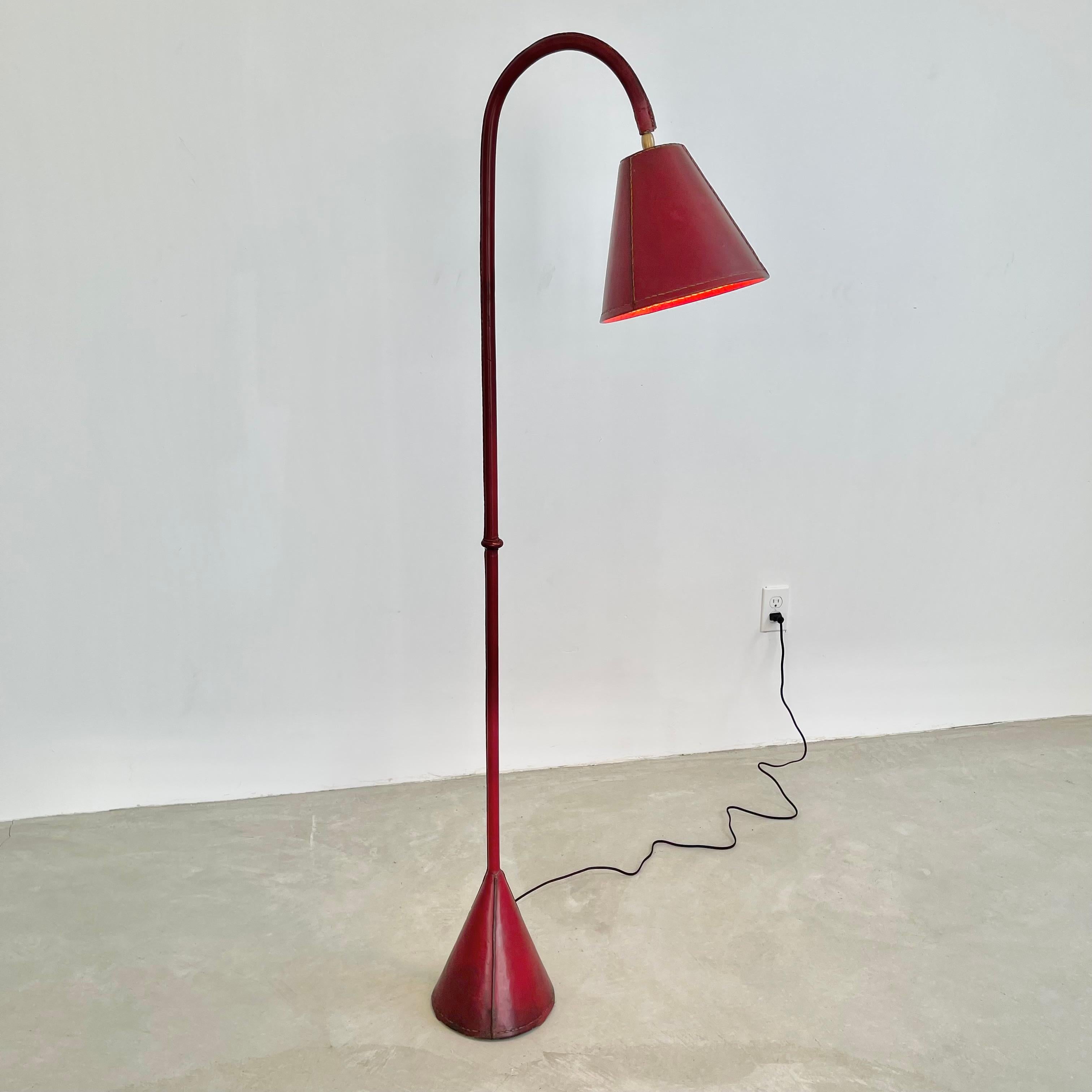 Handsome leather arched floor lamp by Spanish design house, Valenti. Based in Barcelona and founded over 200 years ago, Valenti has deep roots in high end furniture and elegant designs. Made in the 1950s this floor lamp is completely wrapped in a