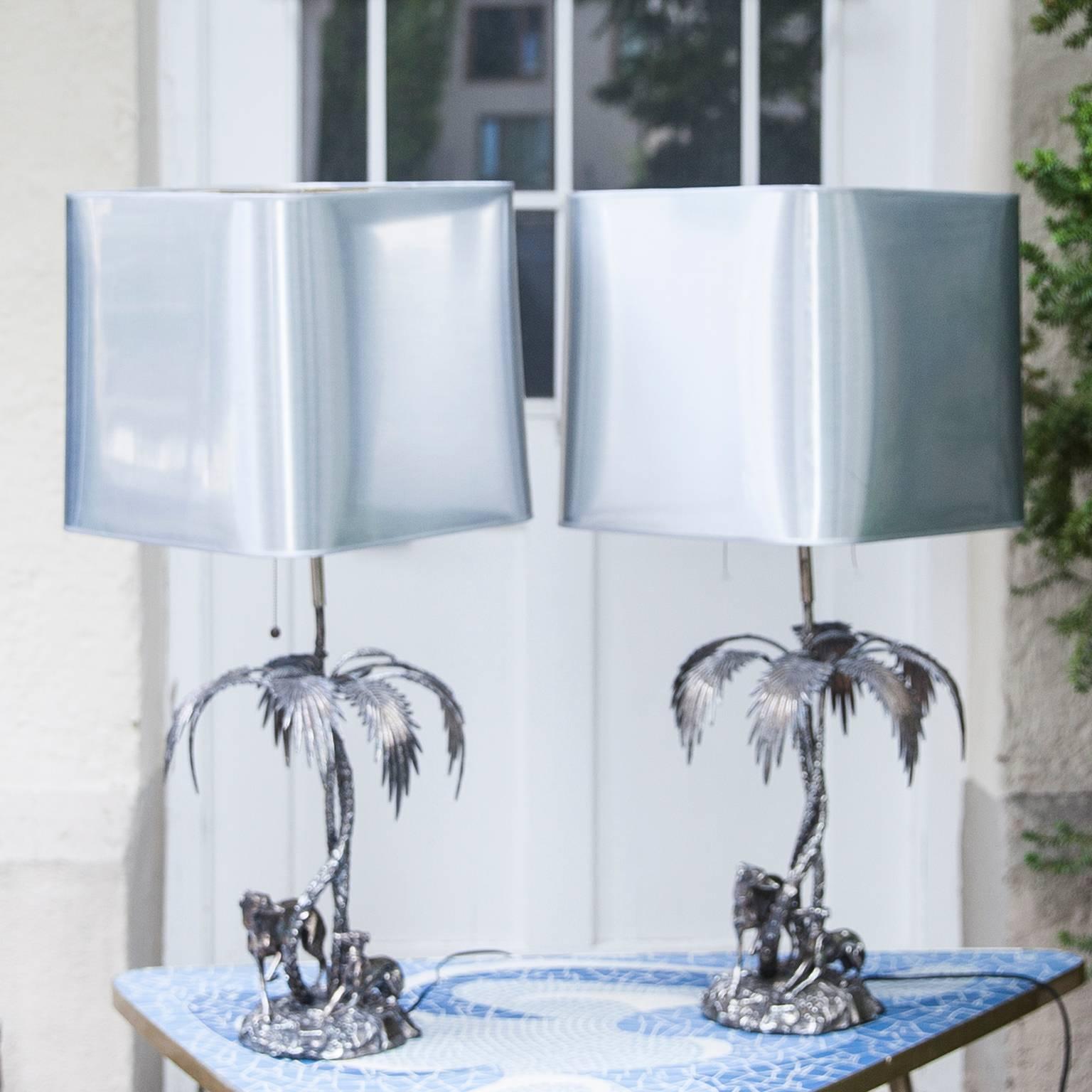 Vintage Valenti table lamps, crafted of fine quality solid silvered bronze, made in Spain 1970s. These Spanish silver plate bronze figural table lamps sculpture depicting greyhounds and palm trees. Marked on base Valenti, Made in Spain.
The shades