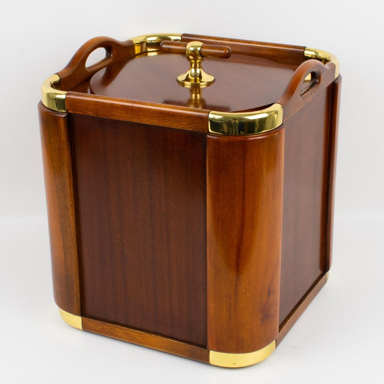 An exquisite modernist 1960s original barware ice bucket or champagne cooler designed by noted Spanish silversmith Valenti & Co. Yachting style with a tropical wood body with gilded brass accents. Plastic container in the inside enough wide and deep