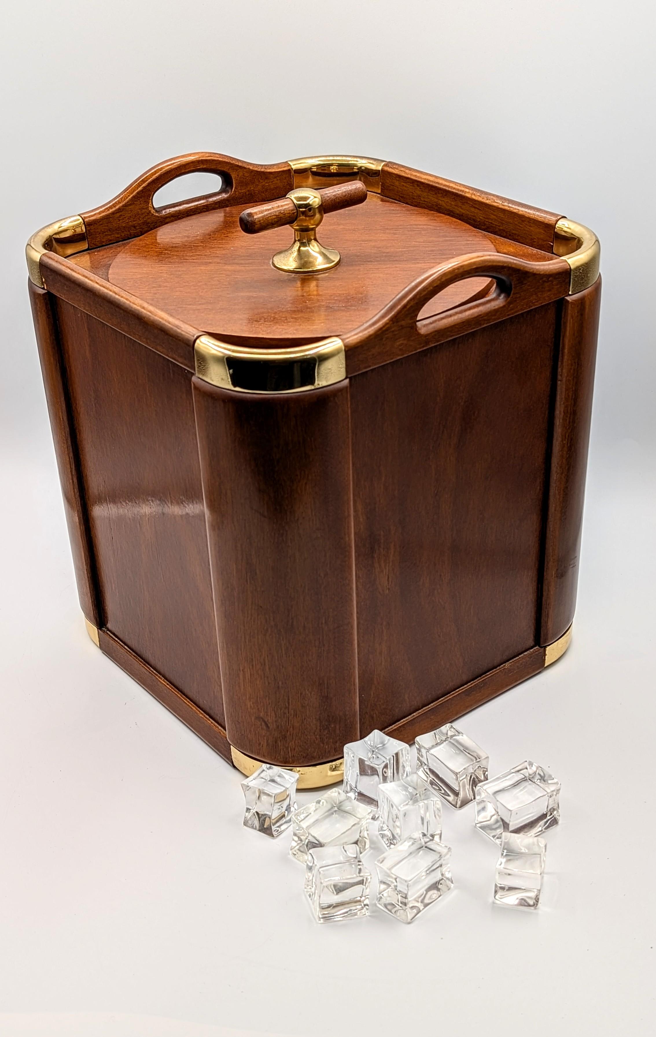 An exquisite modernist 1960s original barware ice bucket or champagne cooler designed by noted Spanish silversmith Valenti & Co. Yachting style with a tropical wood body with gilded brass accents. Plastic container in the inside enough wide and deep