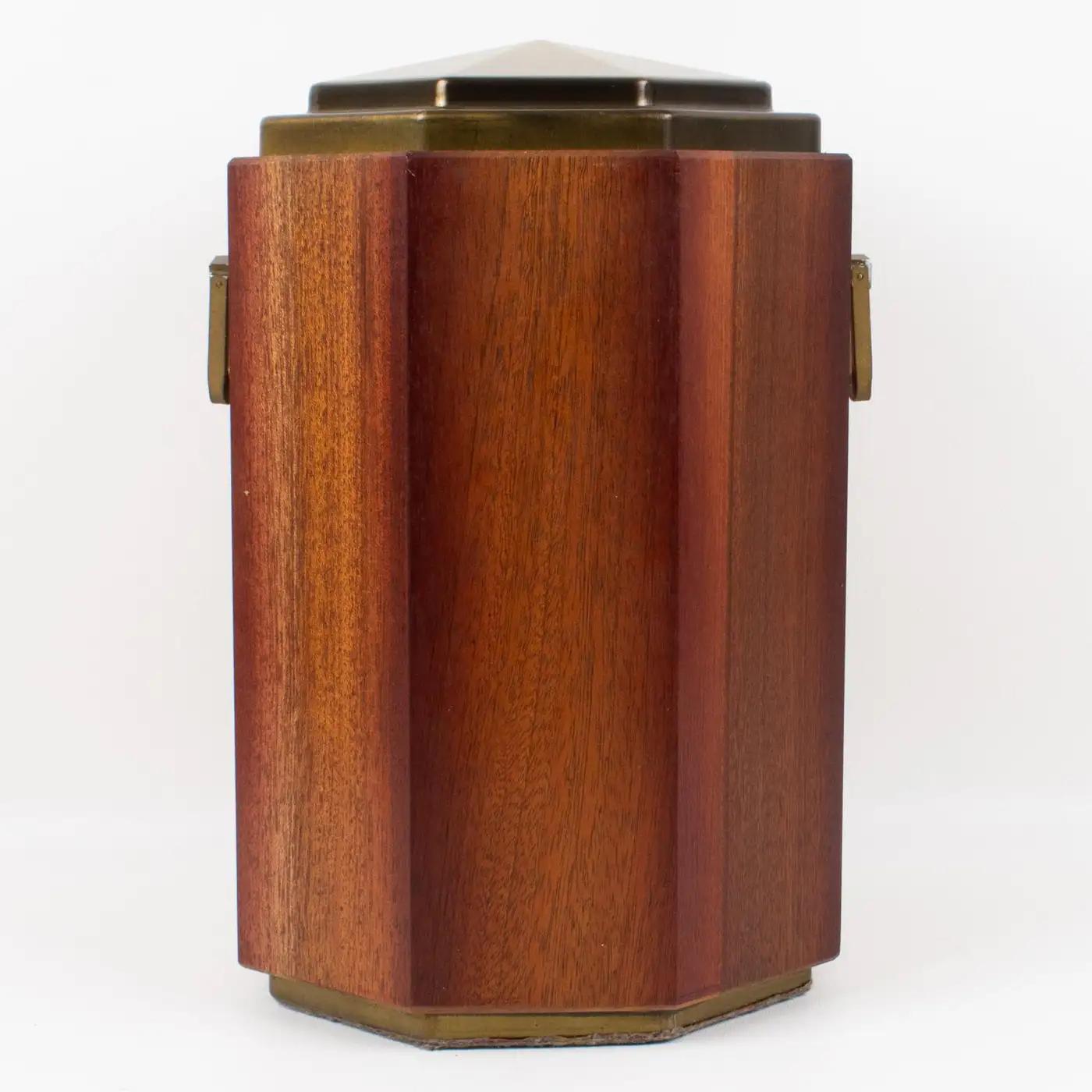 Valenti, Spain, designed this lovely high-end quality modernist decorative lidded box in the 1980s. The yachting style has a tropical wood faceted body with a brass lid and handles. The inside of the box is lined with cobalt blue velvet. There is no