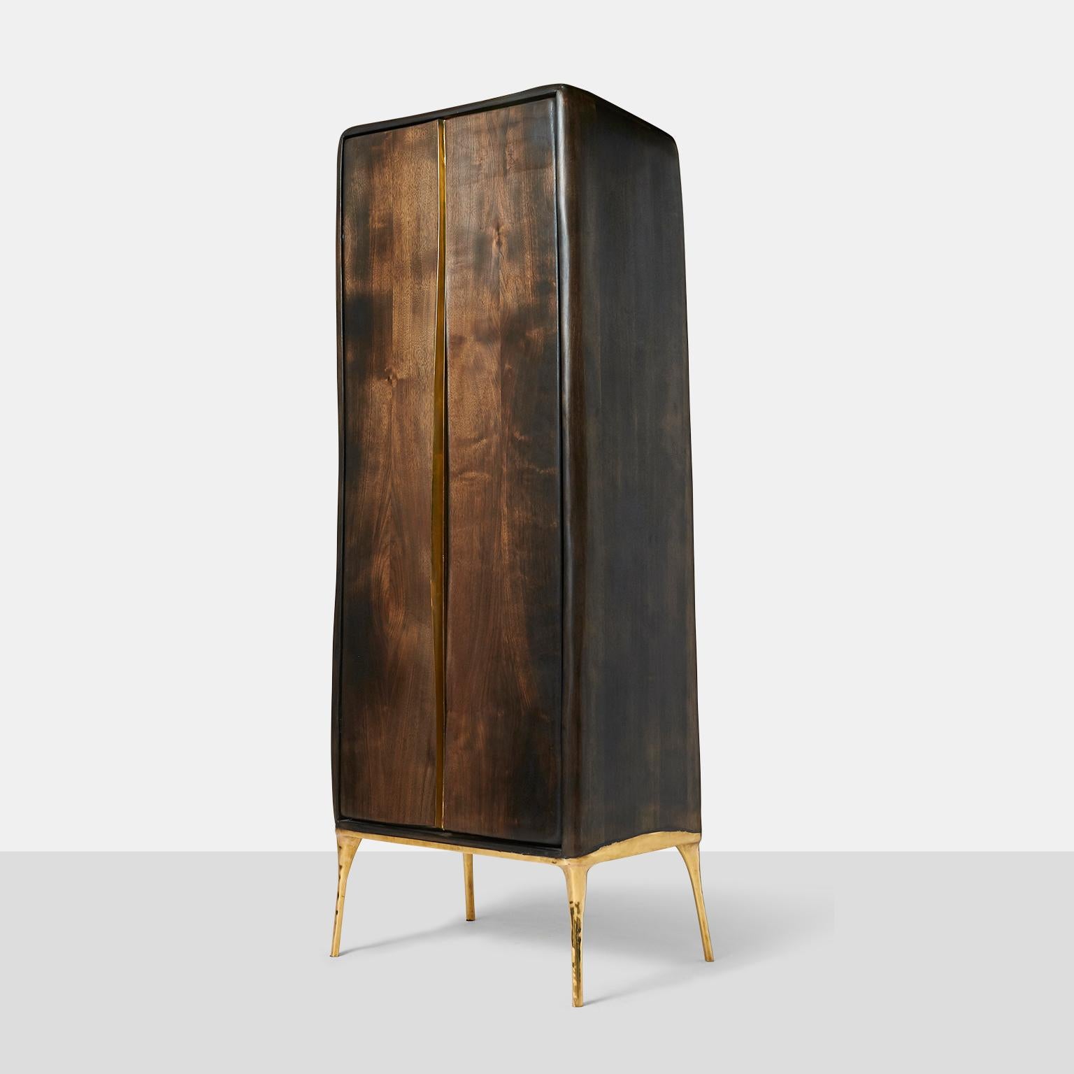 Valentin Loellmann, Armoire
An organic shaped two-door armoire in walnut with brass lined doors and door pulls. The cabinet top has a downsloping shape to the back.
Netherlands, c.2017.