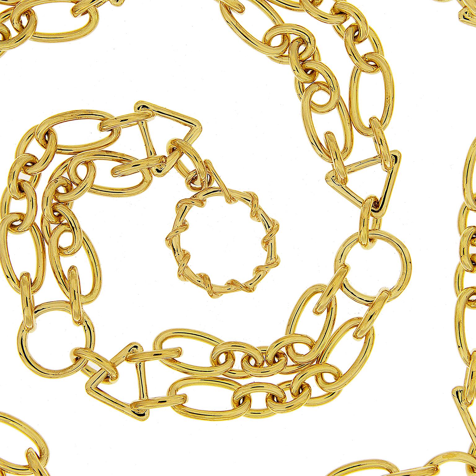 18k yellow gold geometric shapes in a pair create this memorable interpretation of a chain necklace. A circle connects to two rows of an oval, three smaller circle links, and another oval with a triangle link at the end. The pattern continues. A
