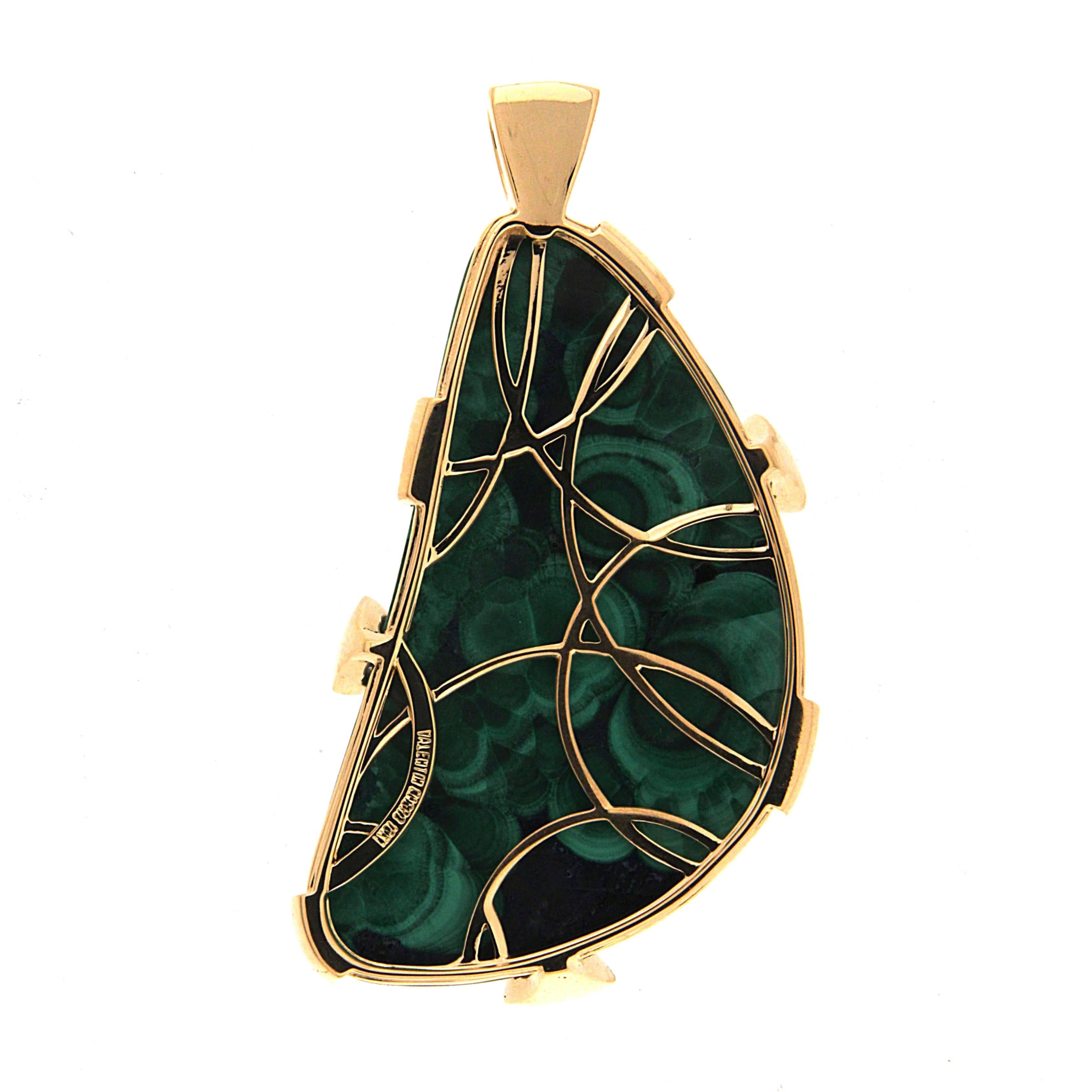 Two gems merge into one in this pendant. Azurite is a dark blue, often opaque gem. Malachite is prized for its banded greens. They both form in copper rich earth, sometimes in the same location, becoming a single rock. Here, malachite appears as