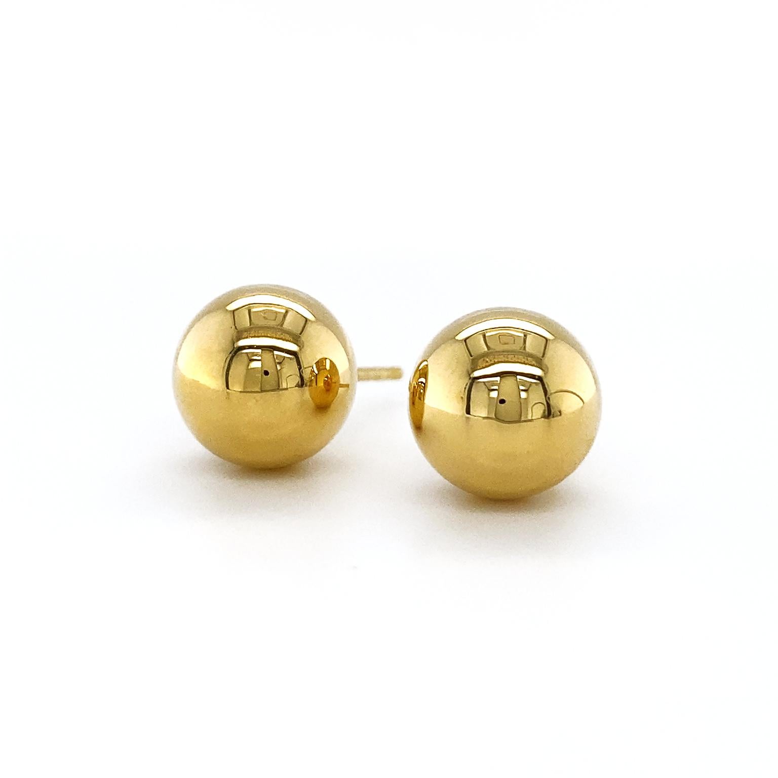 Valentin Magro Ball Stud Earrings in Yellow Gold showcase bright elegance. Everything is made of 18k yellow gold, giving the design warm tones. The decorative elements are spheres with a reflective polish. Post and friction backs secure the