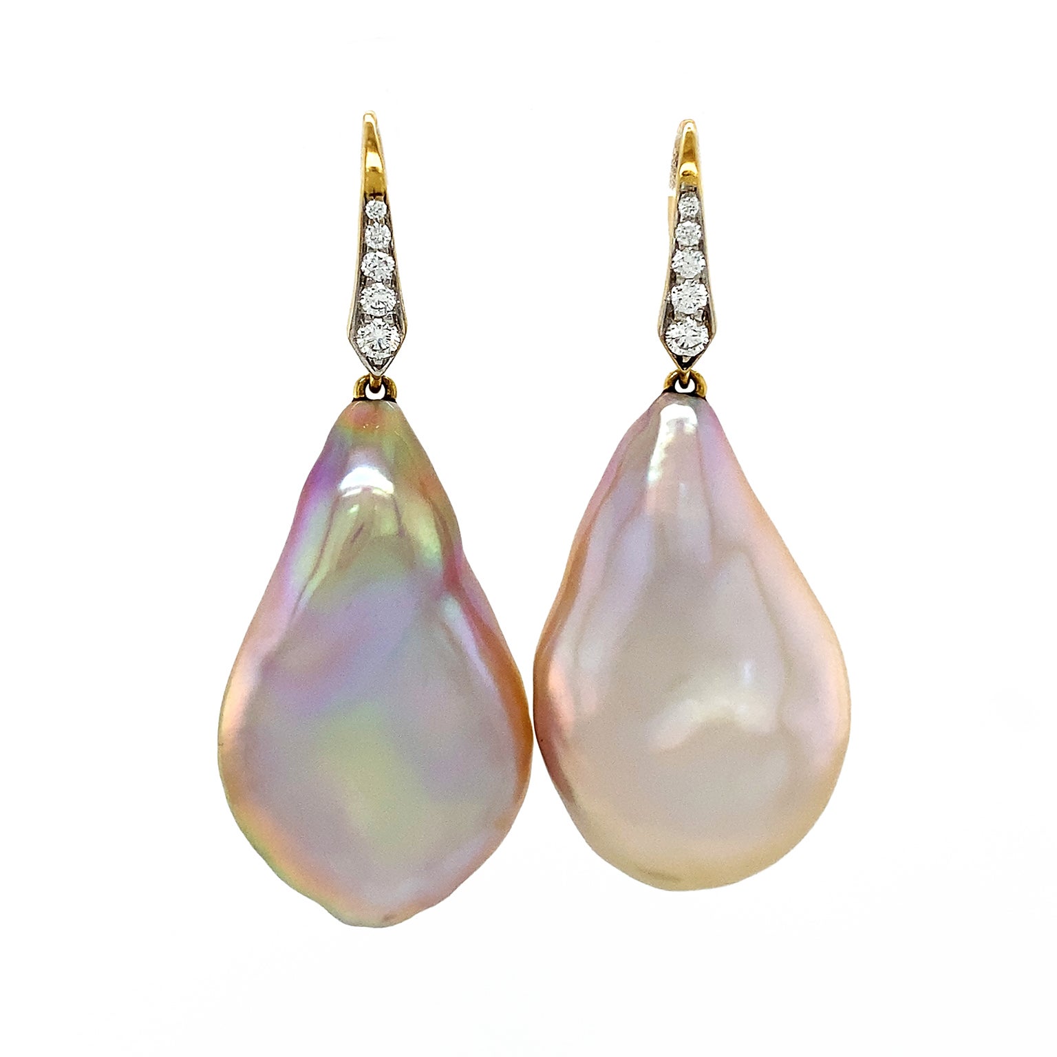 Baroque freshwater pearls are acclaimed in these drop earrings. 18k yellow gold lever backs with pave set brilliant cut diamonds glimmer as they suspend pearls of an irregular teardrop shape. While the bodies have a delicate warm overtone, the light