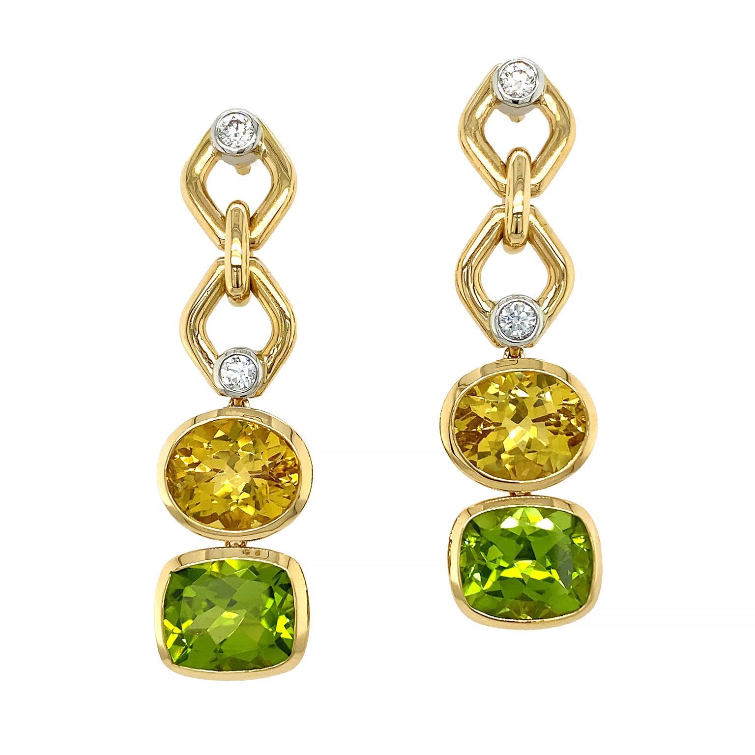 Gold serves as a glinting companion to jewels in these drop earrings. Two rhombuses, with a single brilliant cut diamond, are connected. This leads to an oval shaped deep yellow beryl, following a cushion shaped vibrant peridot. Total weights of the