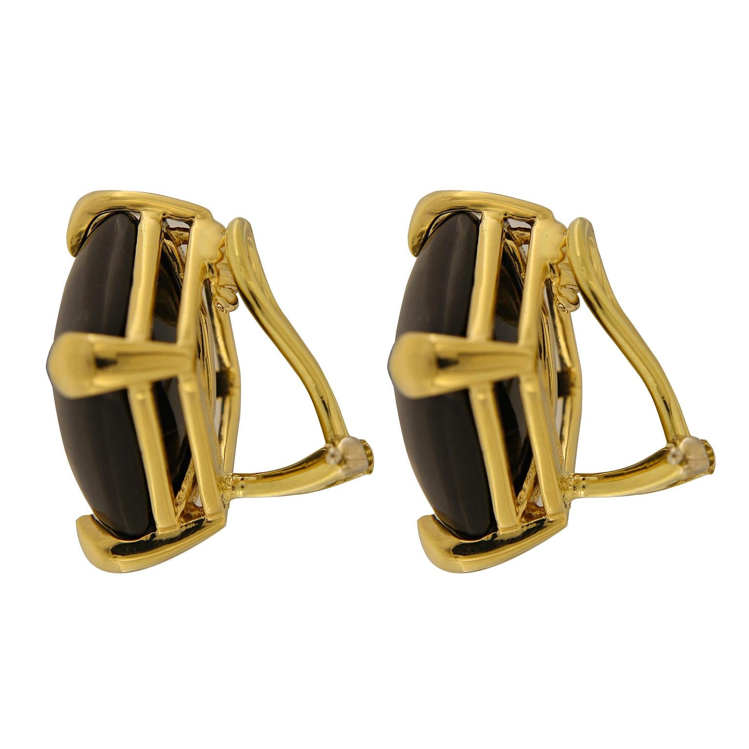 Lustrous black coral is accentuated by the glow of 18k yellow gold for these earrings. Black coral is carved into a cushion cabochon and rotated as a rhombus for intrigue. 18k yellow gold claws secure each corner and serve as an accentuating color