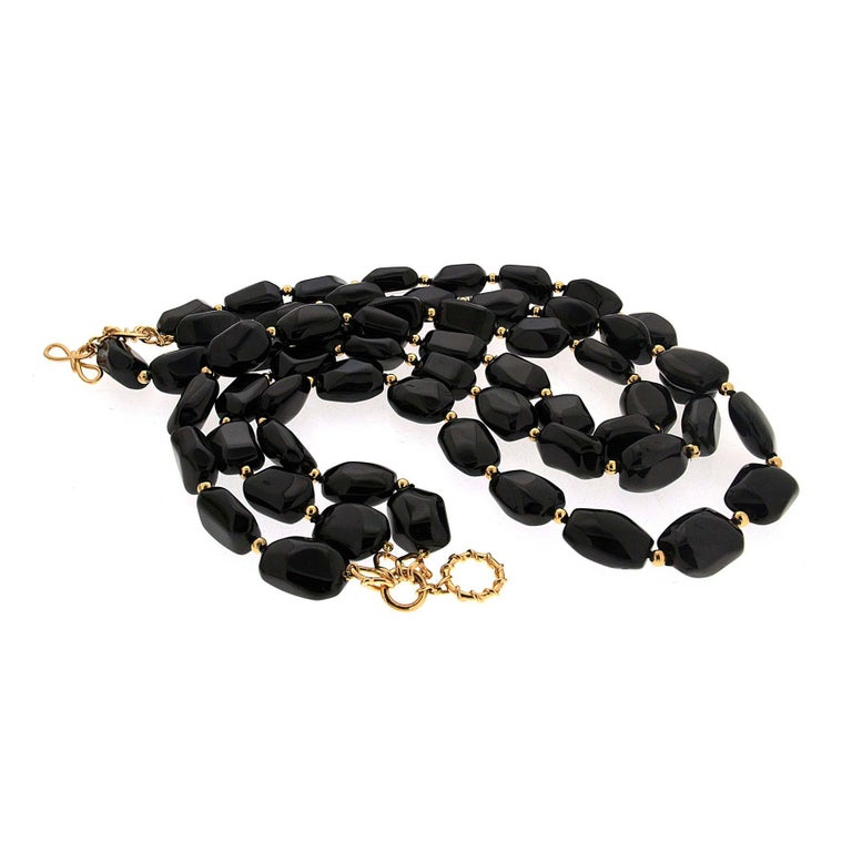 This necklace is both understated and extravagant. Black spinel dominates the necklace, providing a glossy sheen and elegant hue. Beads of 18k yellow gold are bright accents. The spinel is special cut into irregular, pebble-like shapes. They’re