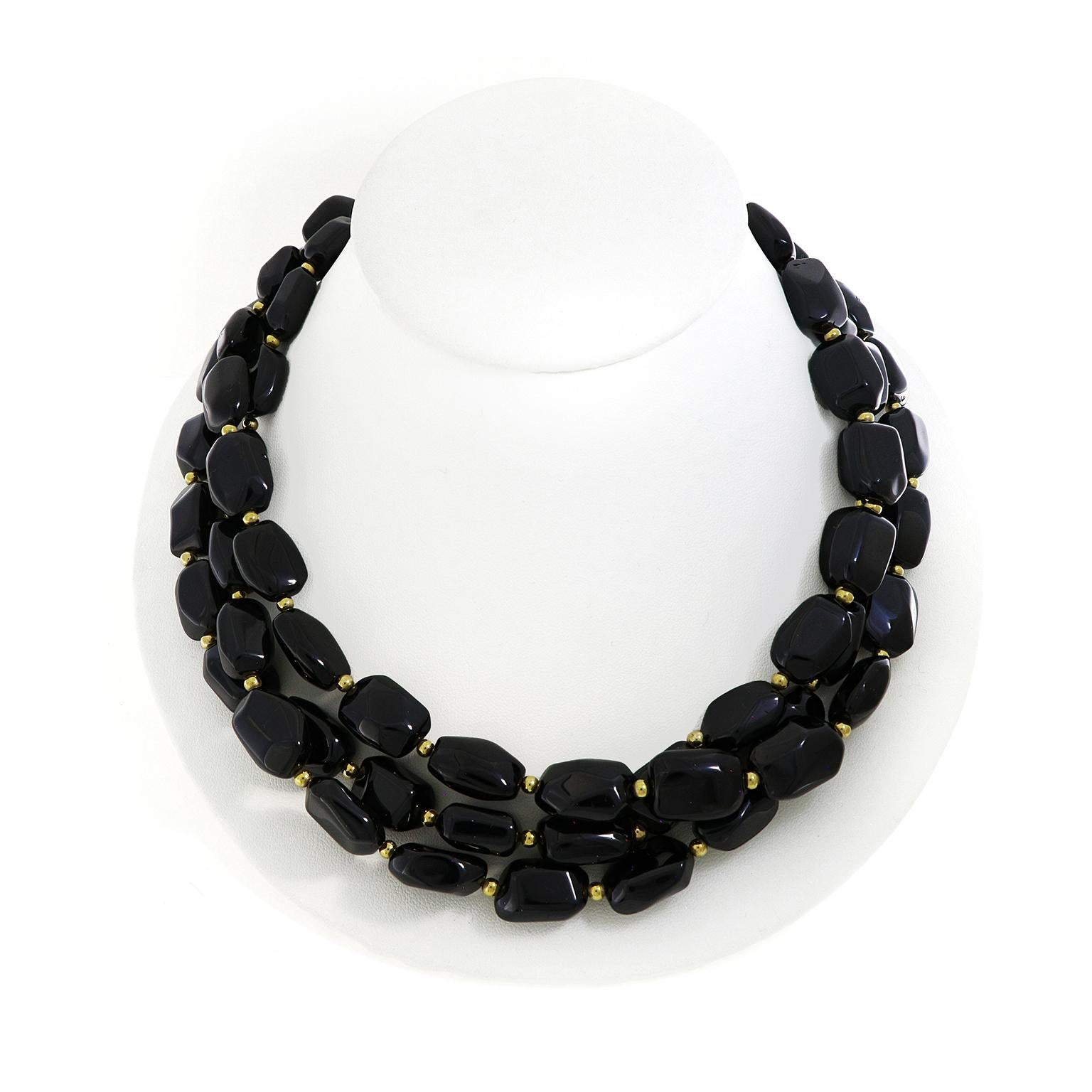 The rare gemstone, black spinel, is the focus of this necklace. Special cuts of the gem allow the light to reflect the shine its known for. In between each black spinel is a single round gold bead for a vivid complement. The three separate strands