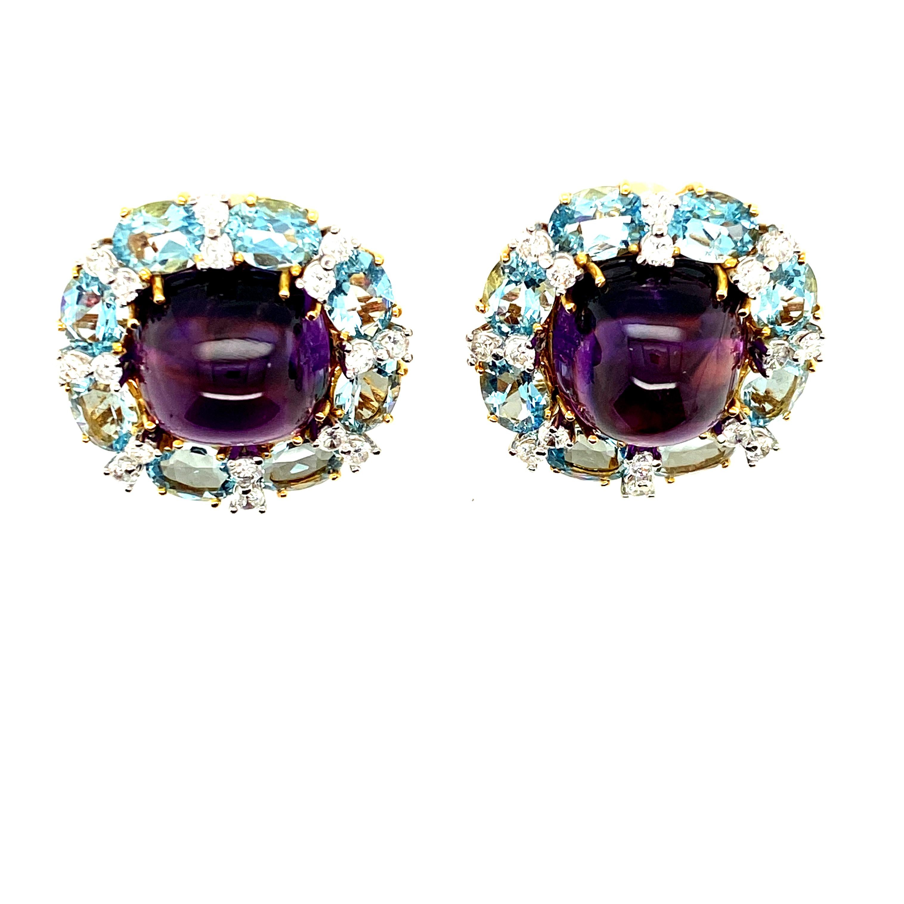 This pair of earrings from famed New York jeweler Valentin Magro features two uniform and eye clean cabochon amethysts, surrounded by a halo of alternating aquamarines and an estimated 1.6cts of diamonds.  In addition to the creative design, which