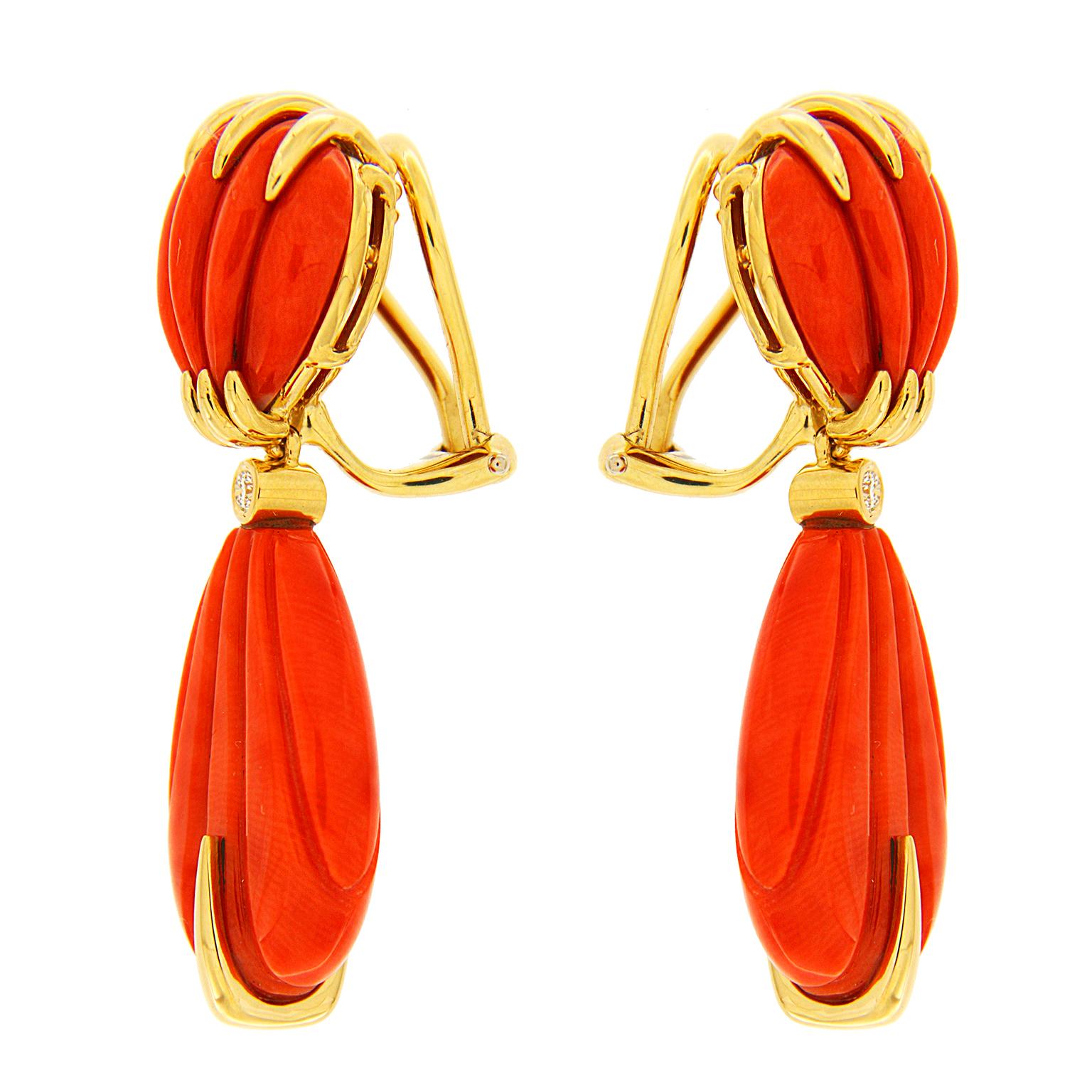 Valentin Magro Carved Red Coral Earrings with Gold Accent Wires are embellished with rounds and points. The featured jewel is coral, repurposed and carved into fluted shapes. The upper gems are rounded while the hanging pieces are drops. Round