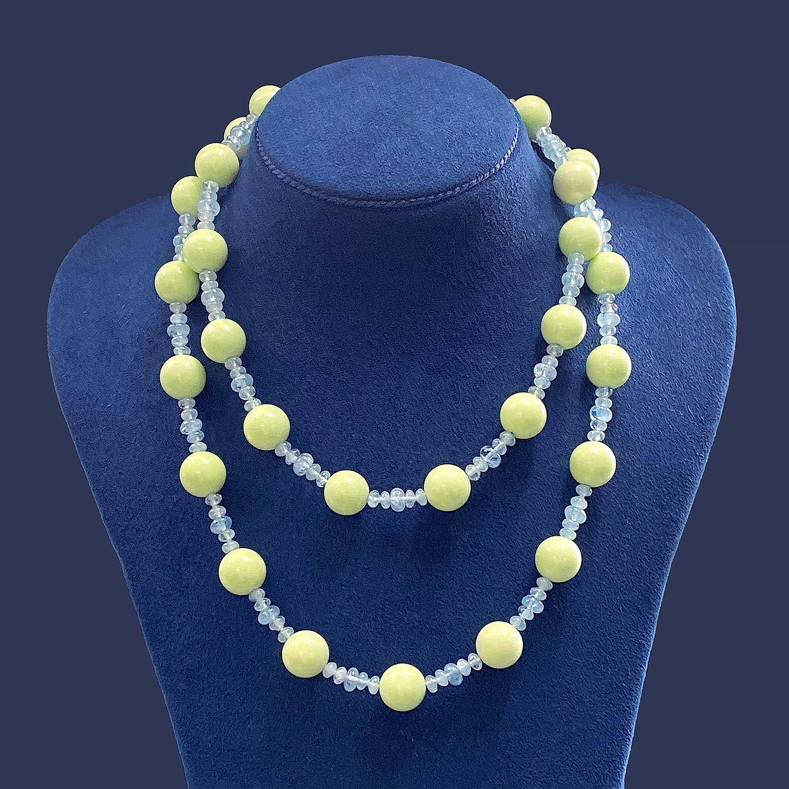 Exquisite mid-tone green in chrysoprase is highlighted in this necklace. Globes of the gem rotate throughout, while five aquamarines accent in between each gem. Rondelles of aquamarine vary, creating an arrangement of two pairs on each side of a
